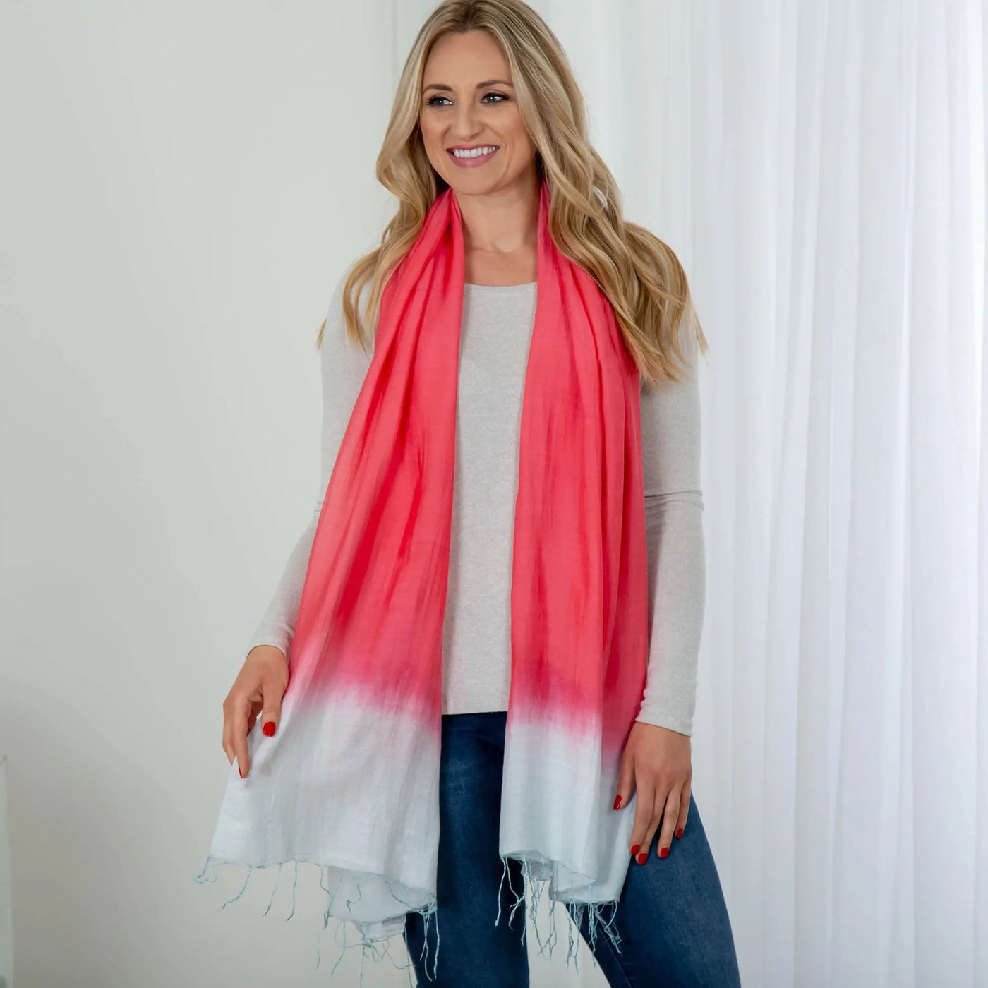 Color Connection scarf featuring a soft coral to white gradient with frayed edges in lightweight fabric