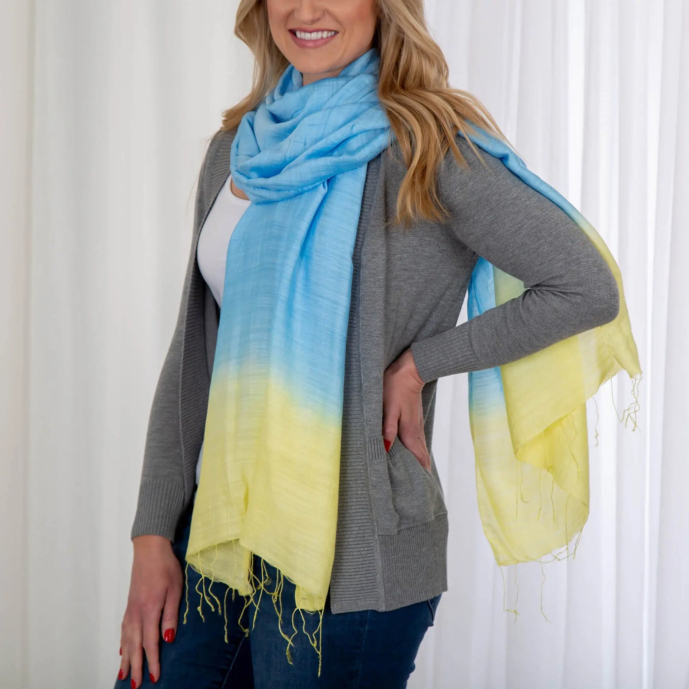 Color connection scarf featuring a soft lightweight fabric with a gradient of light blue fading into yellow
