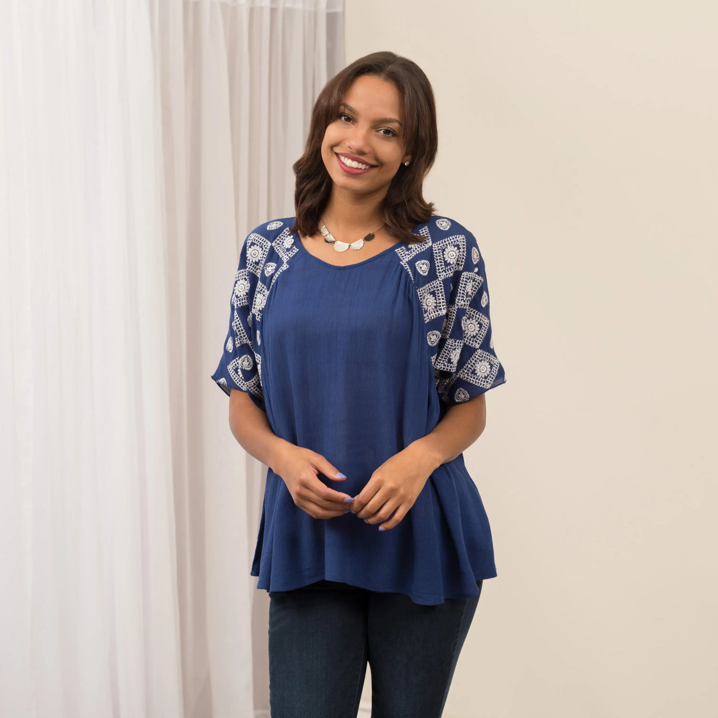 Blue top with white geometric embroidery on sleeves and neckline featuring a peplum hem diamonds on my sleeve top