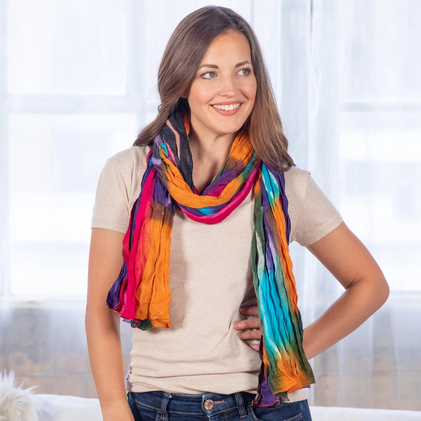 Northern Lights cotton scarf fair trade vibrant tie dye in rainbow hues of orange pink blue and purple draped around neck