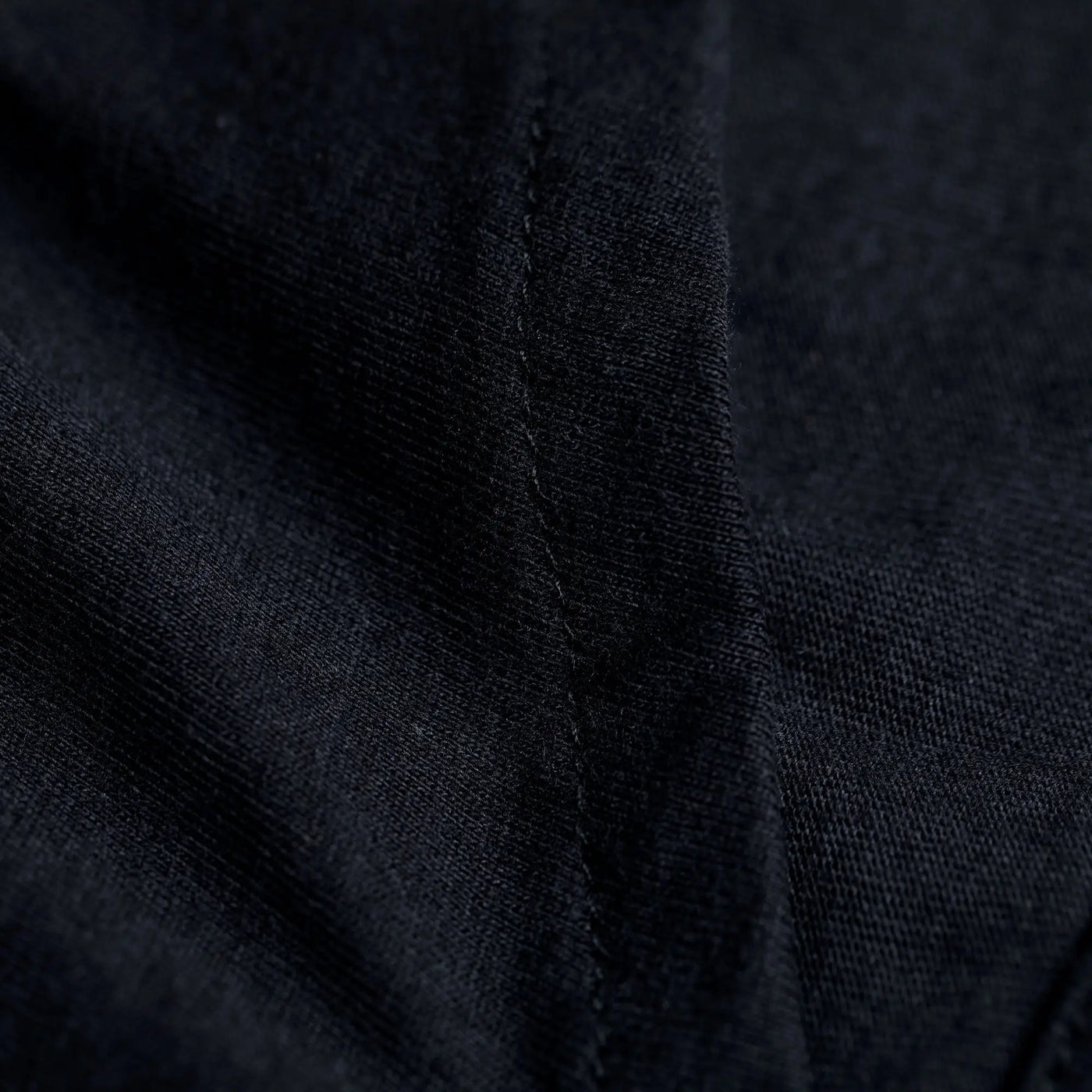 Black textured organic layered pencil skirt fabric with visible stitching close-up detail