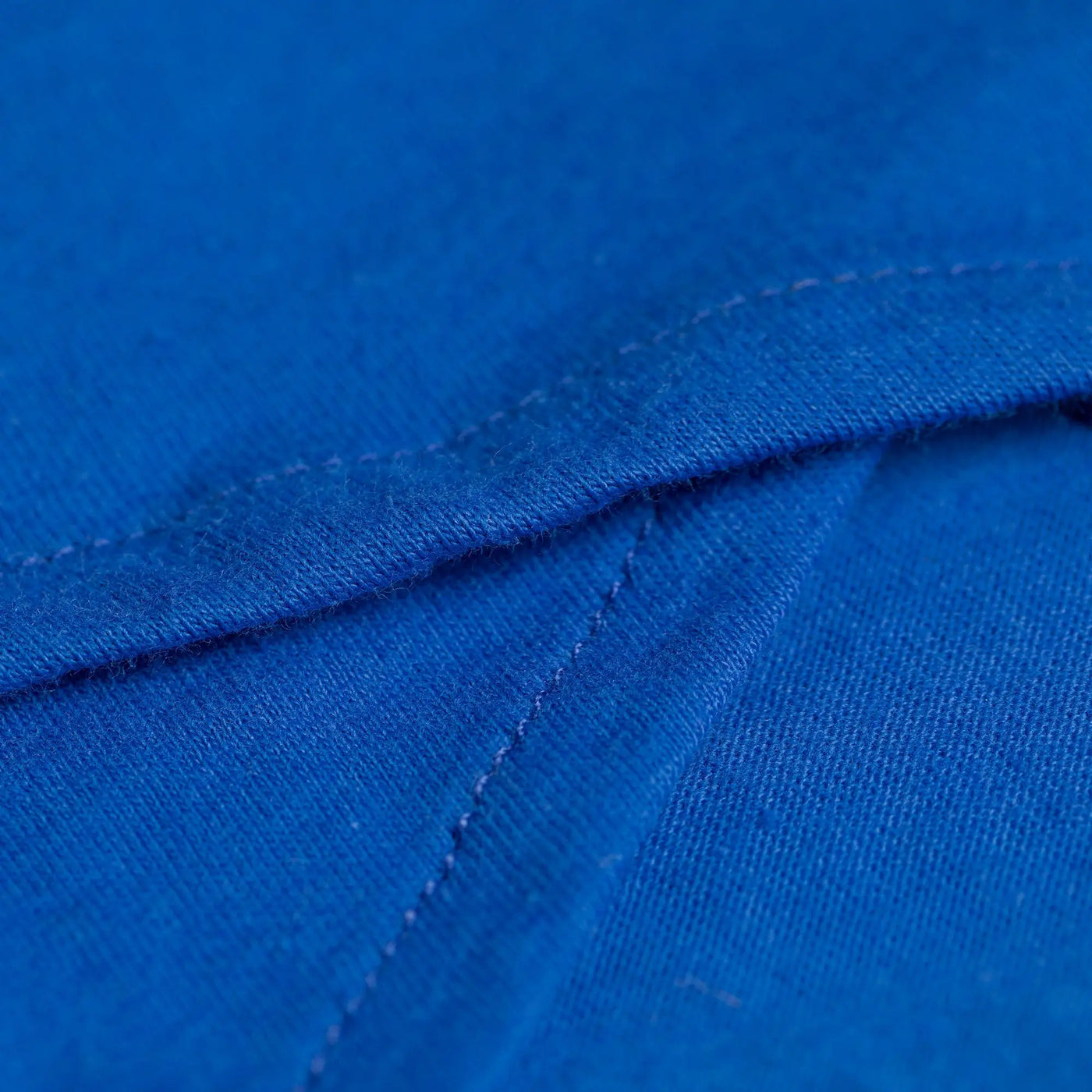 Bright royal blue organic layered pencil skirt made of cotton fabric with visible stitching along the seam
