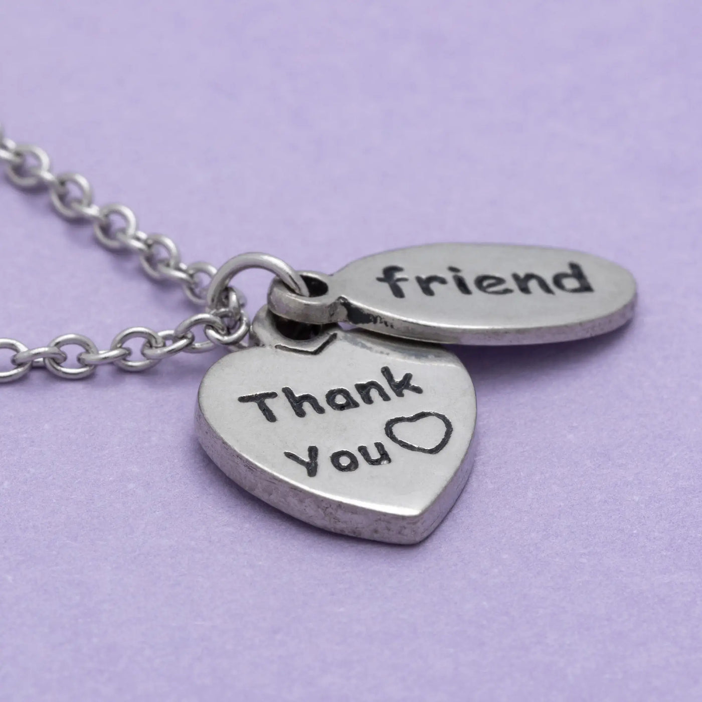 Silver heart and oval pendant necklace engraved with thank you and friend on a delicate chain sisterly love necklace
