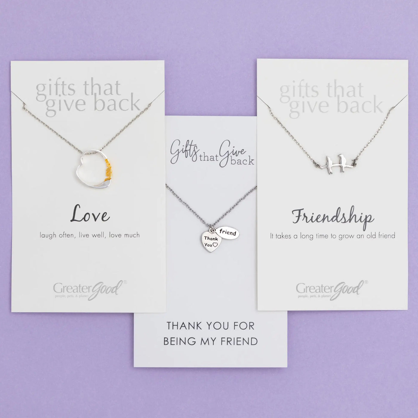 Silver heart-shaped pendant necklace with gold accent featuring love theme on branded card for sisterly love