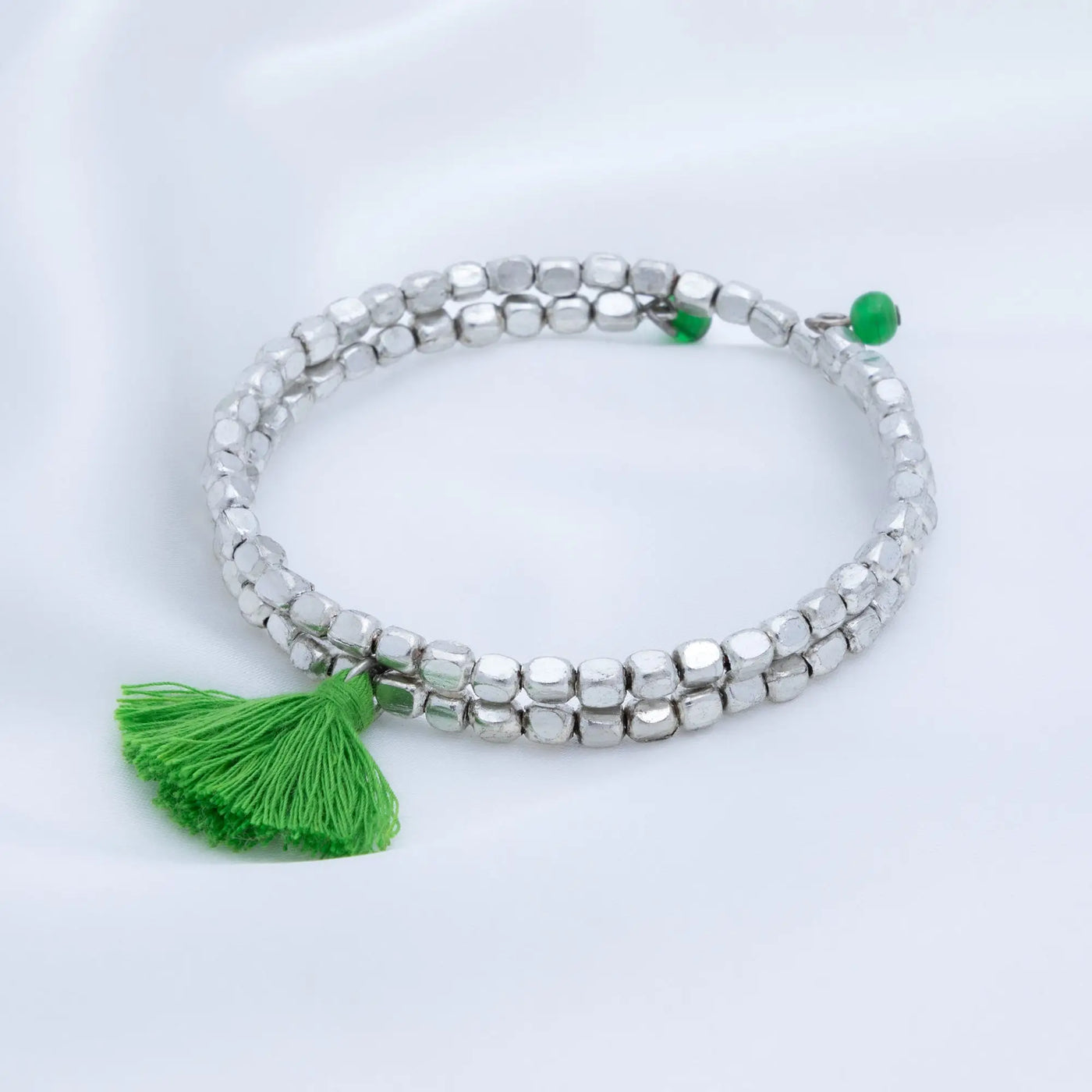 Silver beaded taj tassel metal bead bracelet with vibrant green tassel and matching green accent beads