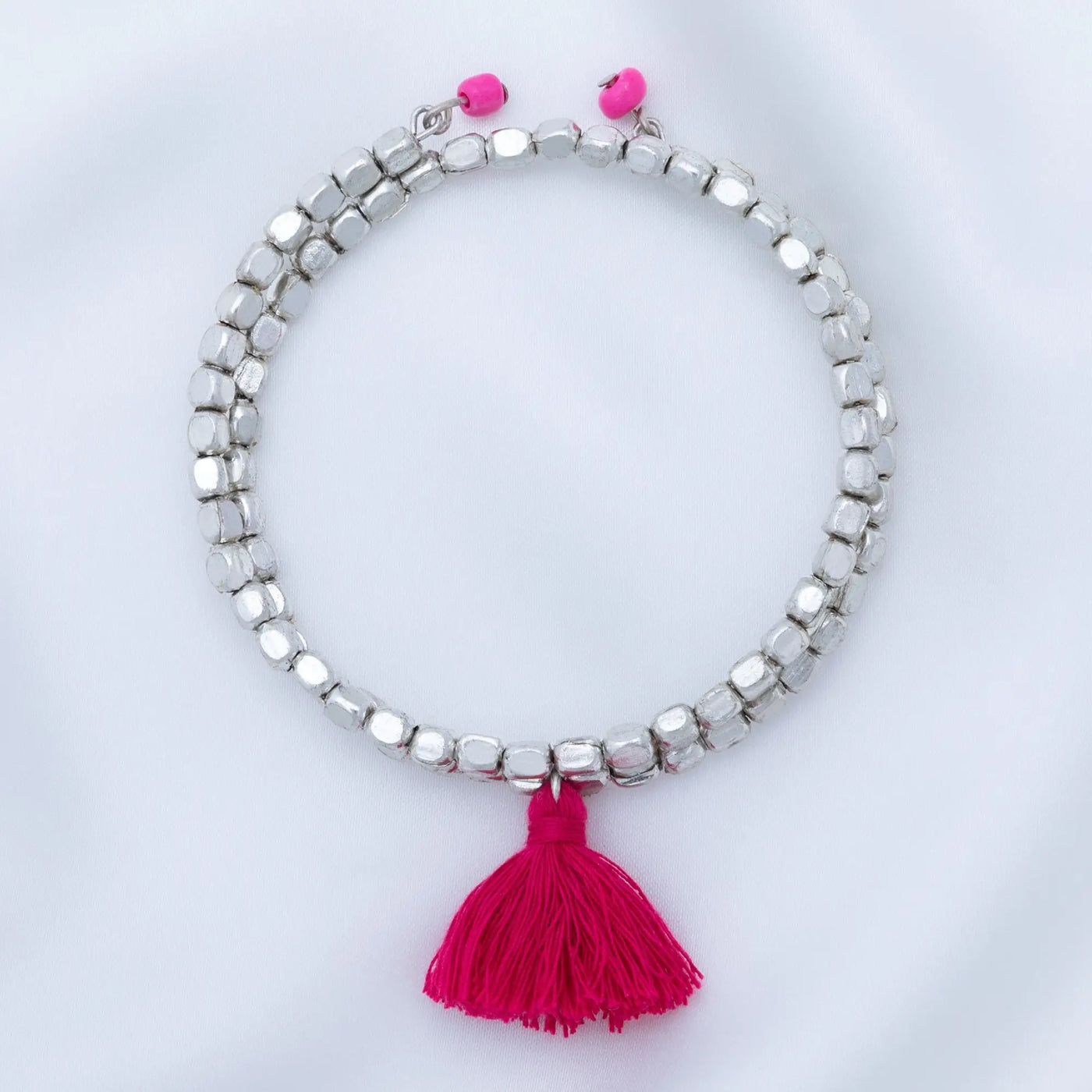 Silver beaded taj tassel metal bead bracelet with vibrant pink tassel and matching pink bead closures