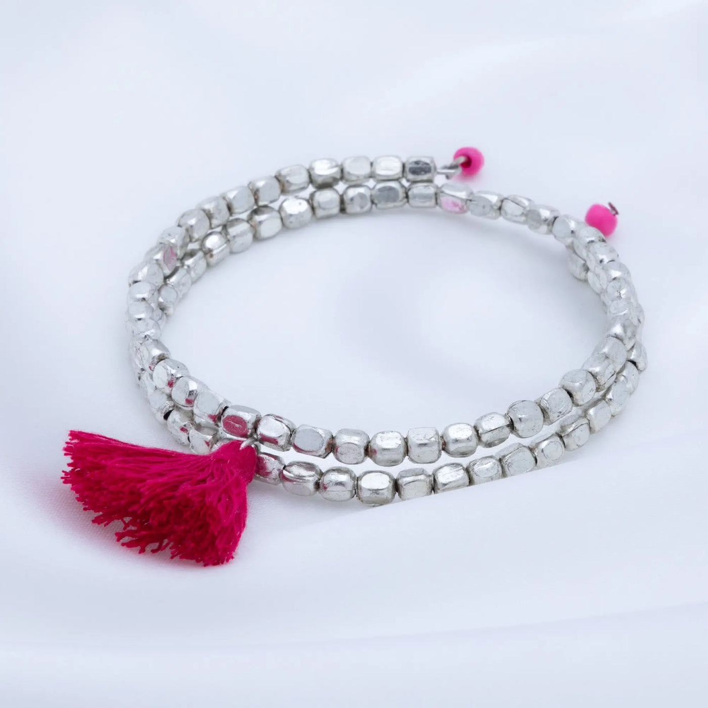 Silver beaded Taj tassel metal bracelet with vibrant pink tassel and matching pink bead accents