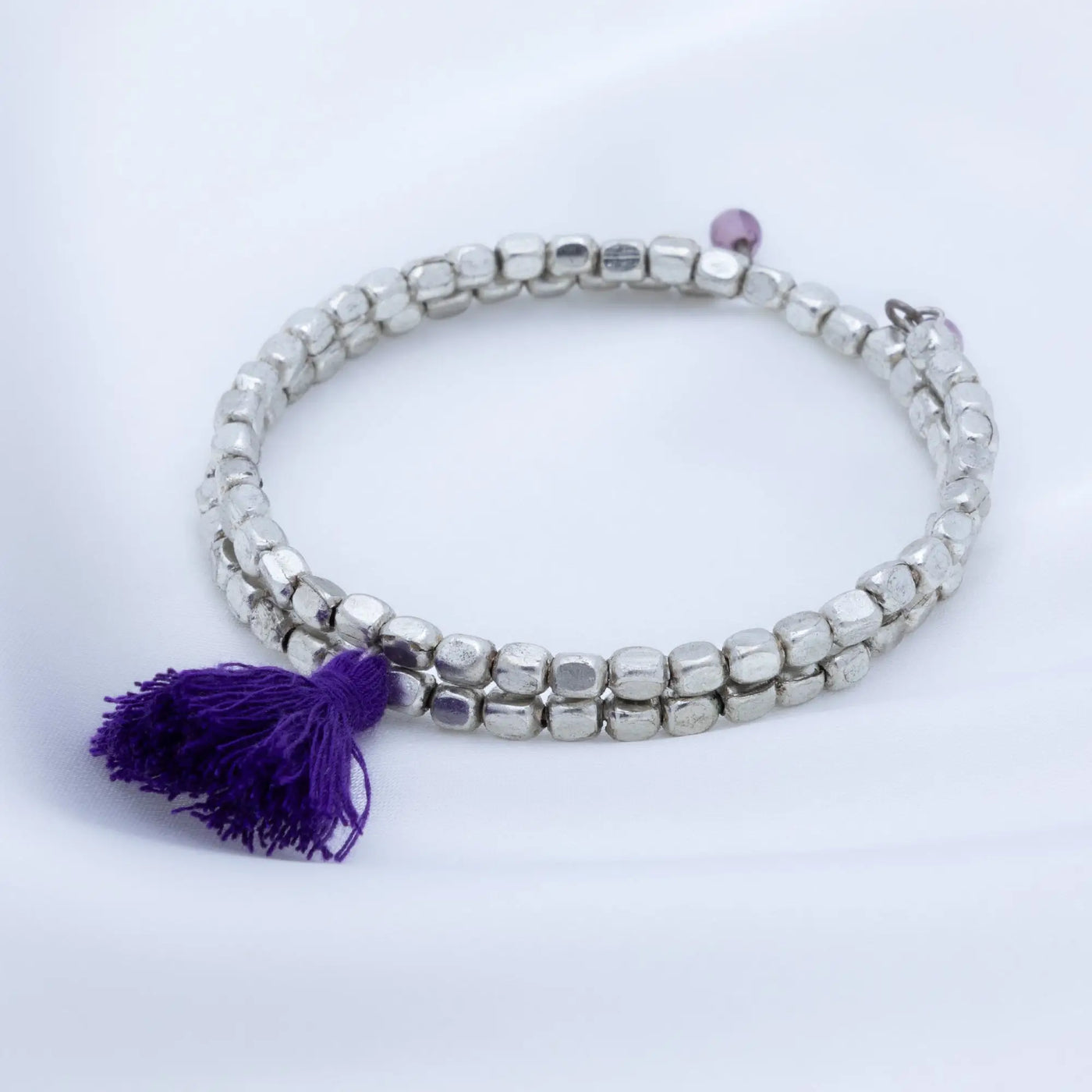 Silver beaded taj tassel metal bead bracelet with a purple tassel accent for stylish wristwear