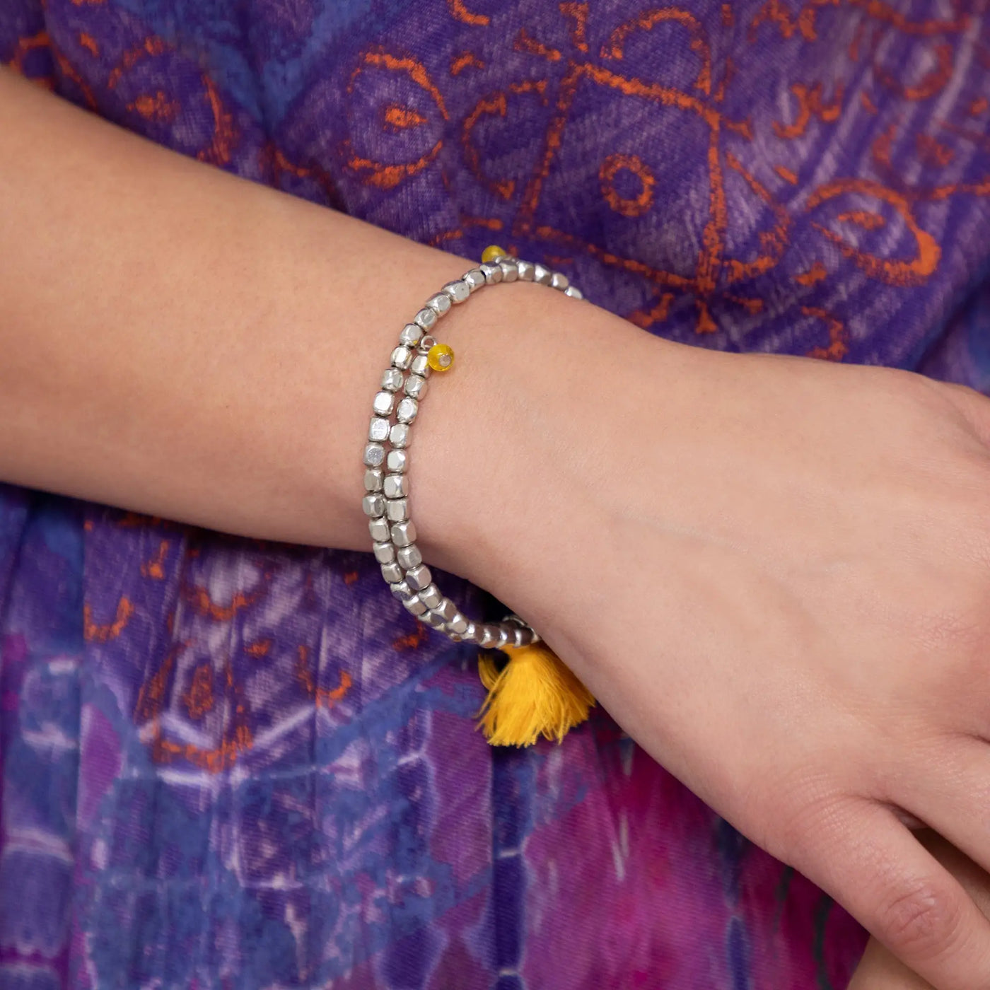 Silver beaded bracelet with yellow tassel and metal accent bead from taj tassel collection