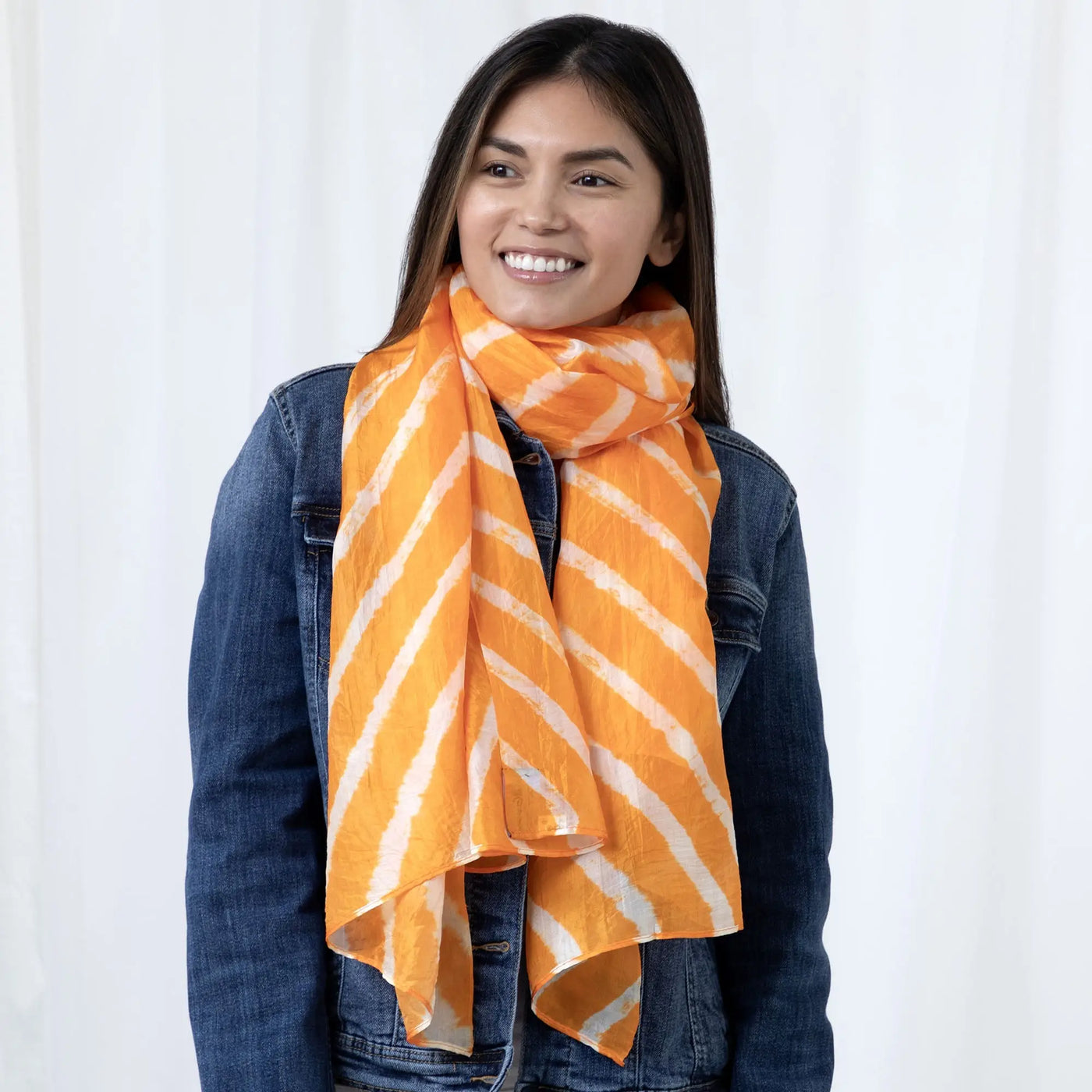 Orange and white diagonally striped tie-dye stripe silk scarf showcasing vibrant colors and smooth texture
