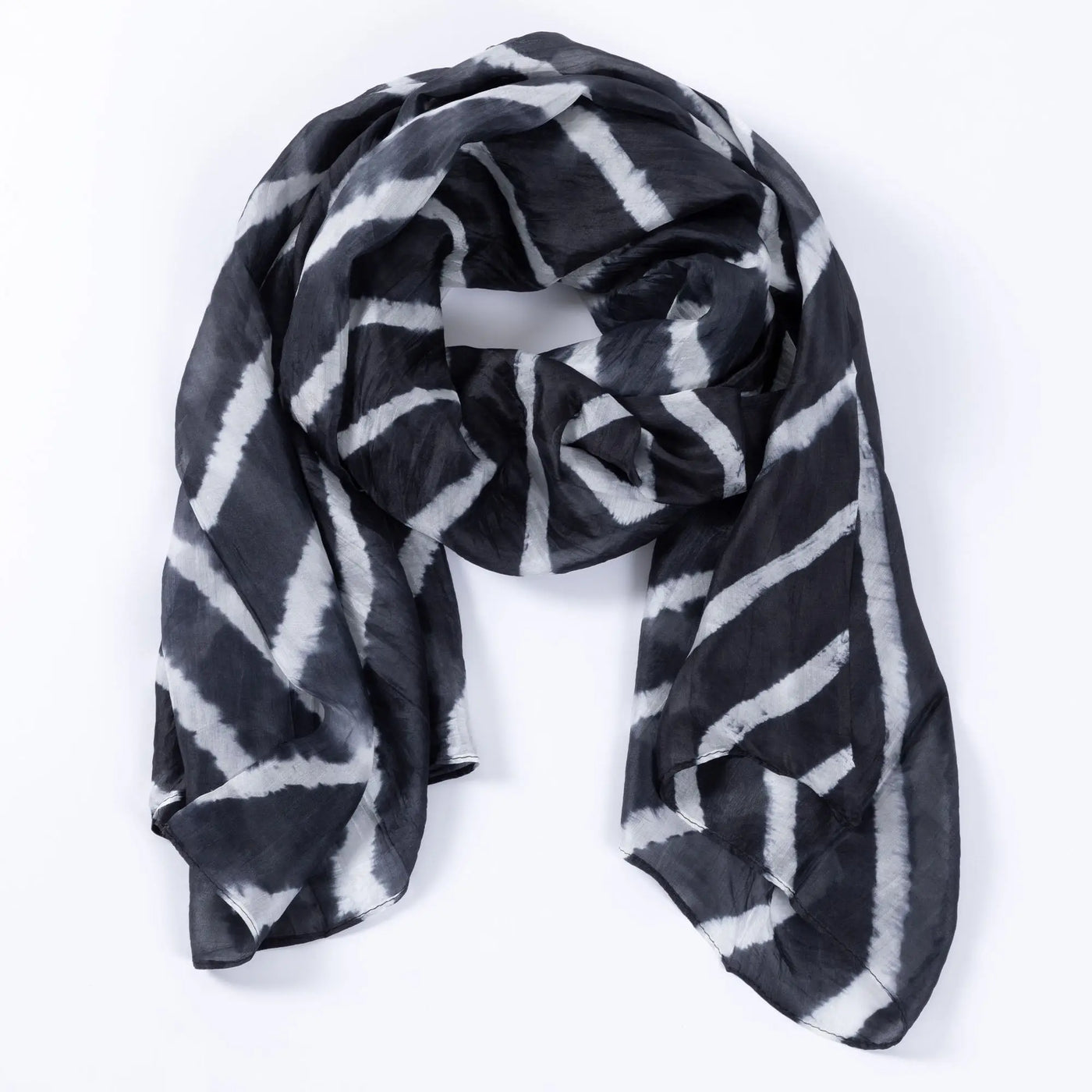 Tie-dye stripe silk scarf in black and white with diagonal stripes made of lightweight flowing fabric