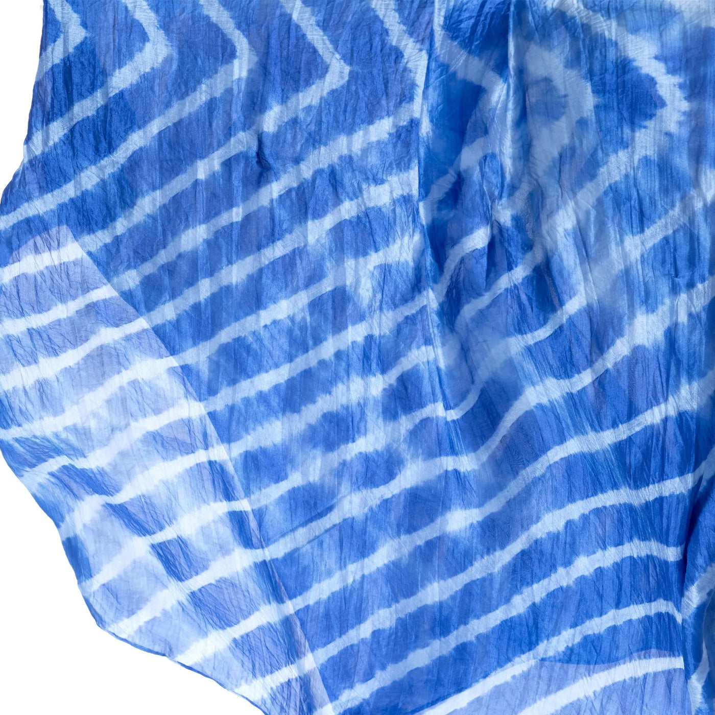 A flowing blue and white tie-dye silk scarf with diagonal stripes perfect for stylish wear
