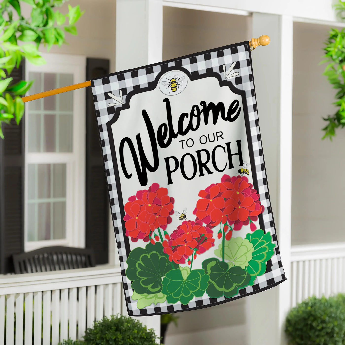 Welcome to our porch geraniums house applique flag with black and white checkered border and red geraniums on white background