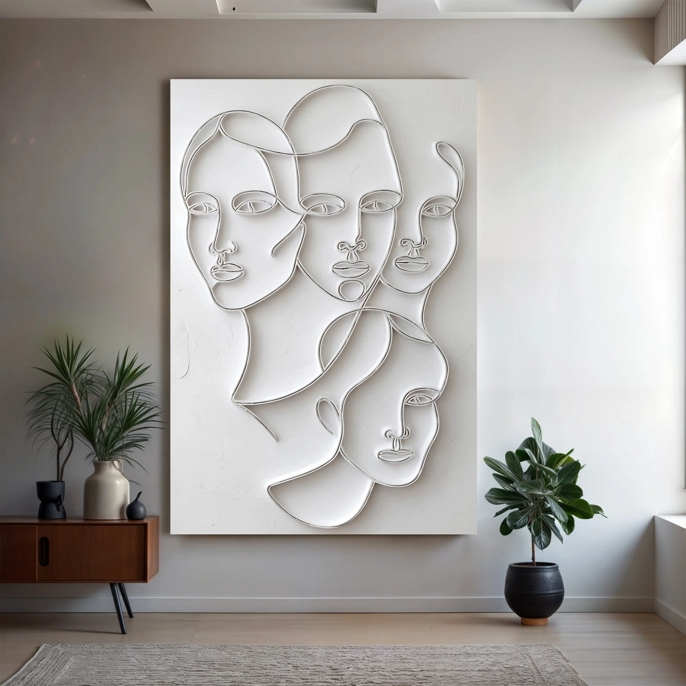 White abstract metal wall art featuring stylized overlapping faces in minimalist line design for modern decor