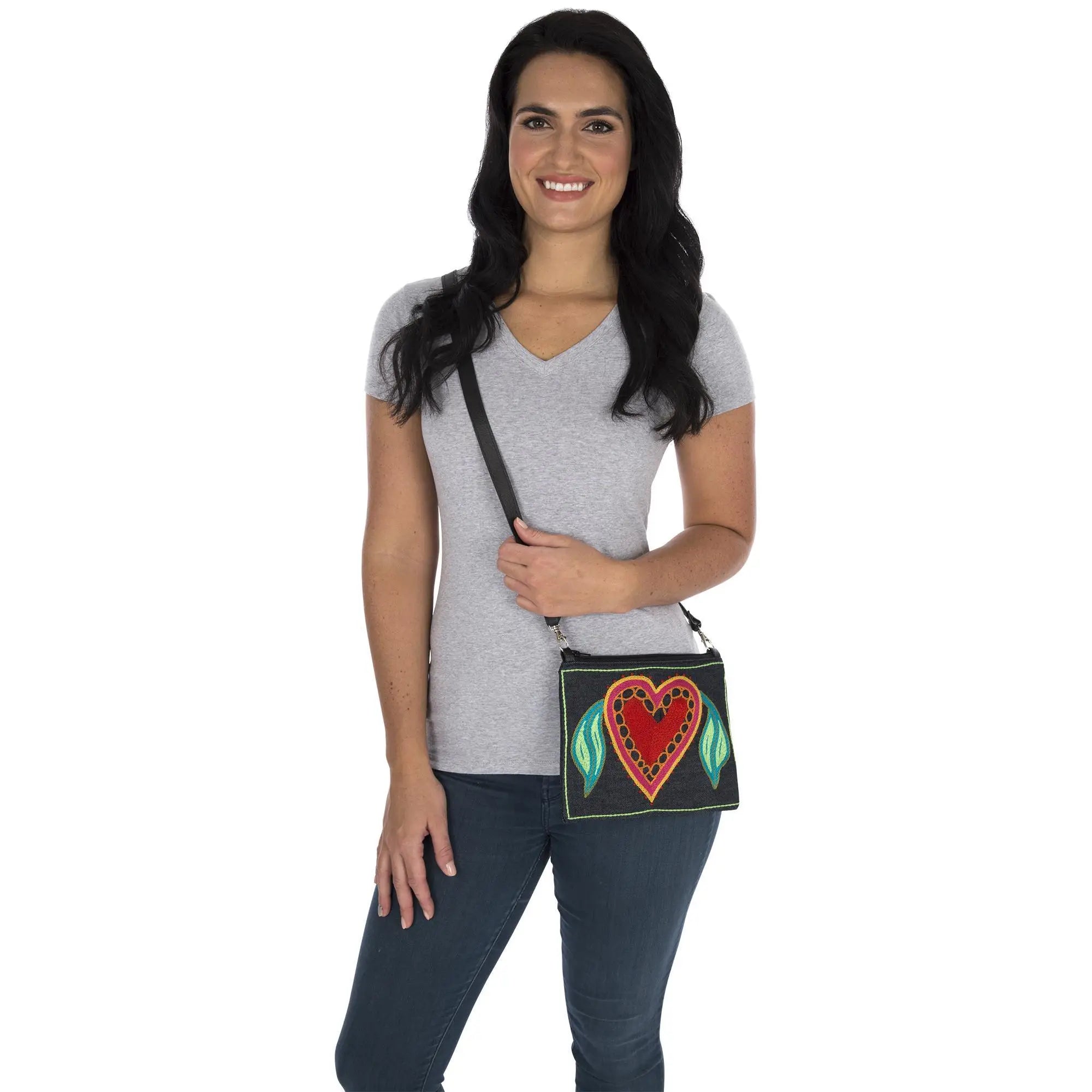 Black Amarasti embroidered sling bag with vibrant red heart and green leaf accents on a crossbody design