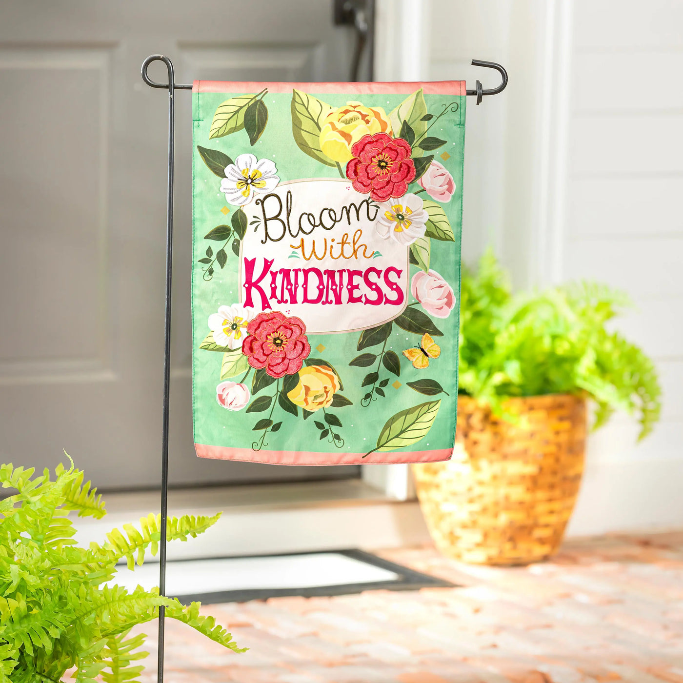 Bloom with kindness applique garden flag with mint green background and colorful floral illustrations in elegant script