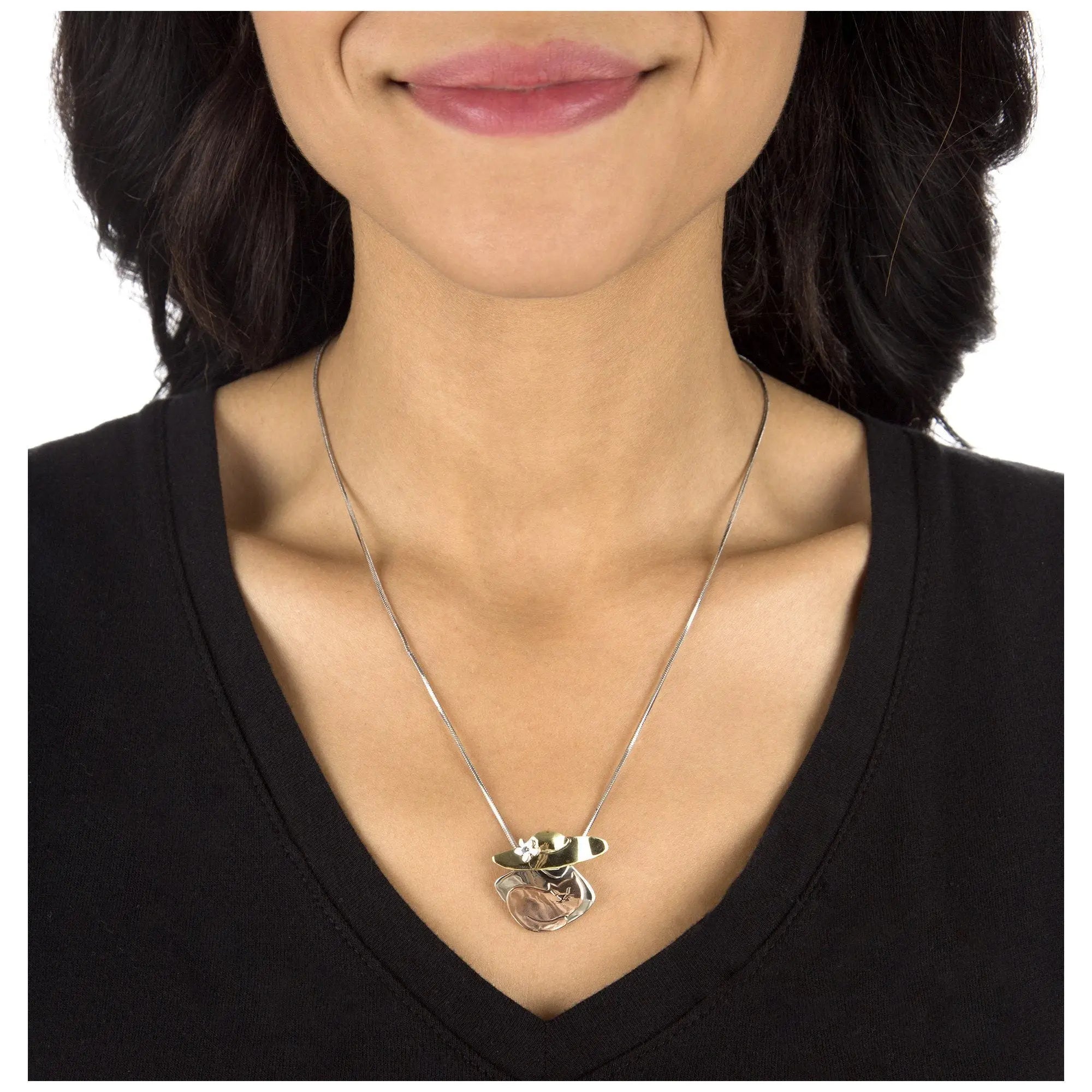Silver-toned cat lover mixed metals necklace with layered abstract floral pendant and central rose quartz stone