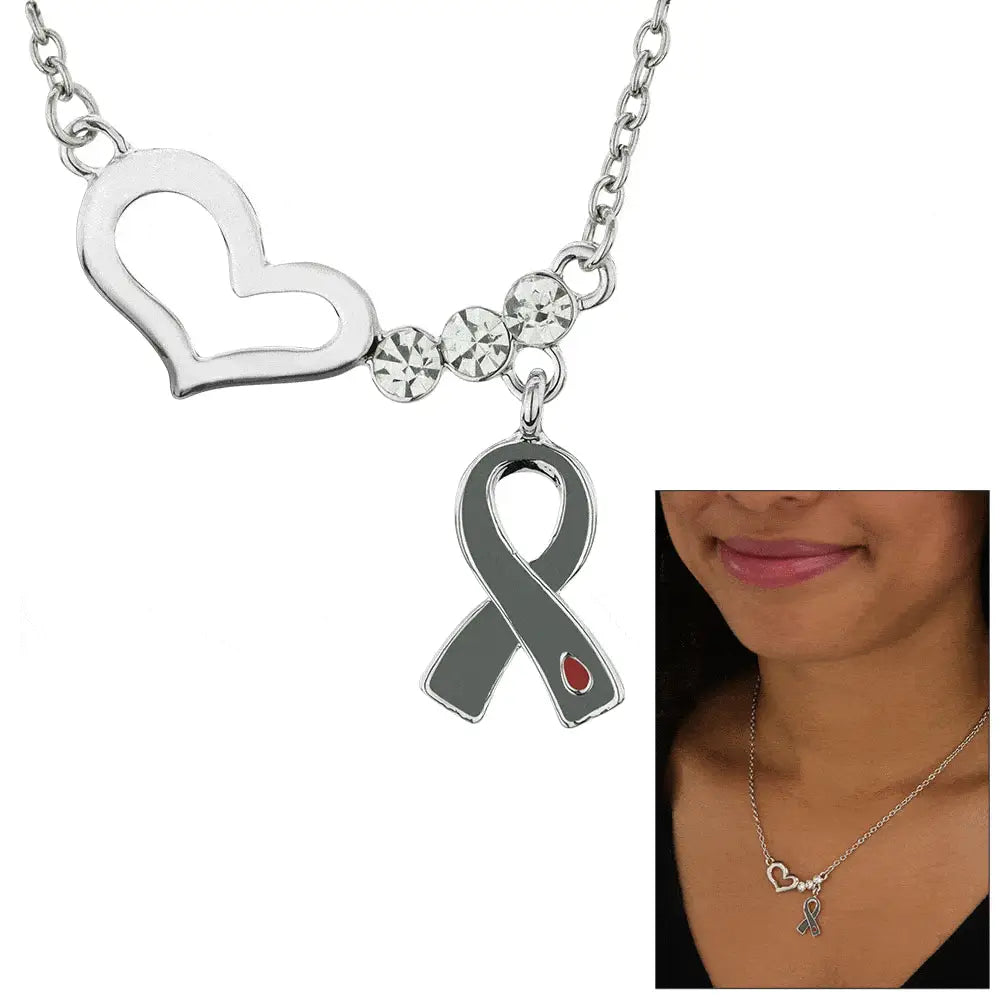 Silver heart-shaped pendant necklace with three clear rhinestones and gray ribbon charm with red drop accent for diabetes awareness