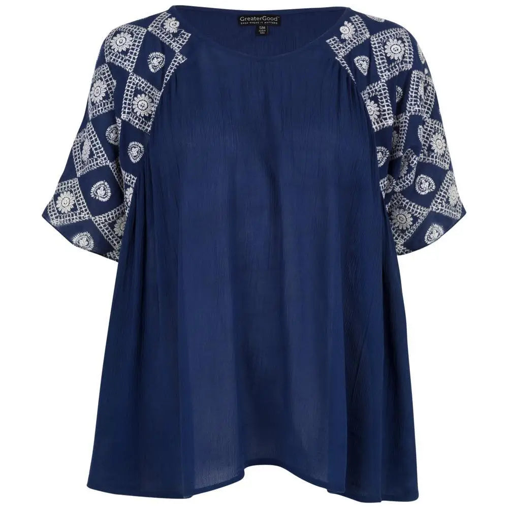 Navy blue diamonds on my sleeve top with white embroidered floral and geometric patterns and short flutter sleeves