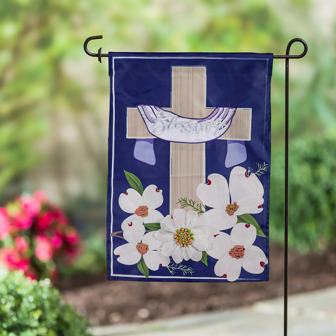 Navy blue garden flag with beige cross and white blessings script adorned with white dogwood flowers and green leaves