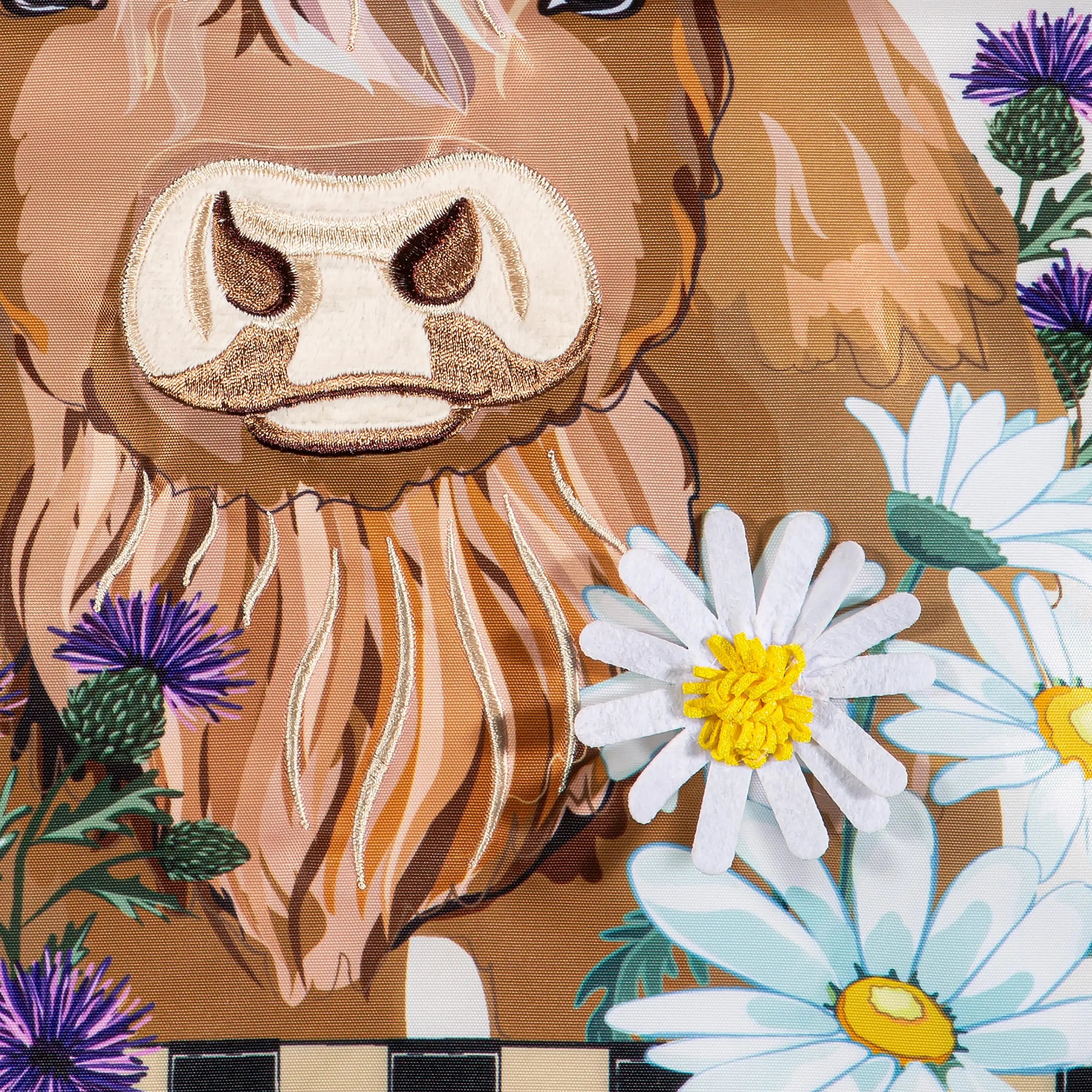 Hillside pasture garden flag with embroidered brown highland cow stitched nose beard and white daisies purple thistles