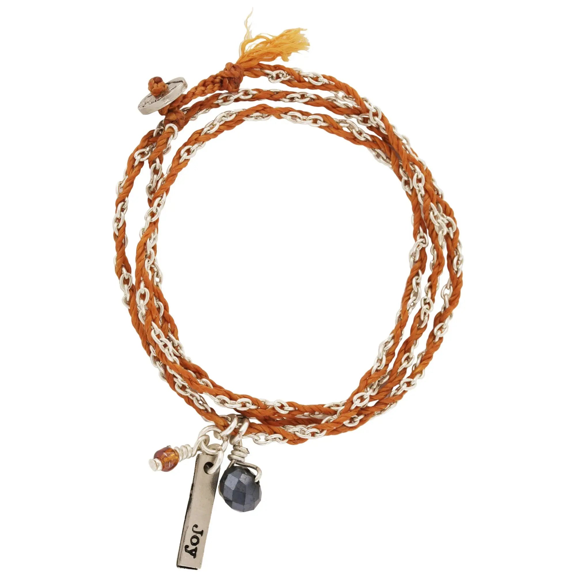 Life’s gifts woven necklace bracelet featuring a multi-strand orange braided leather bracelet with silver chain accents and joy tag