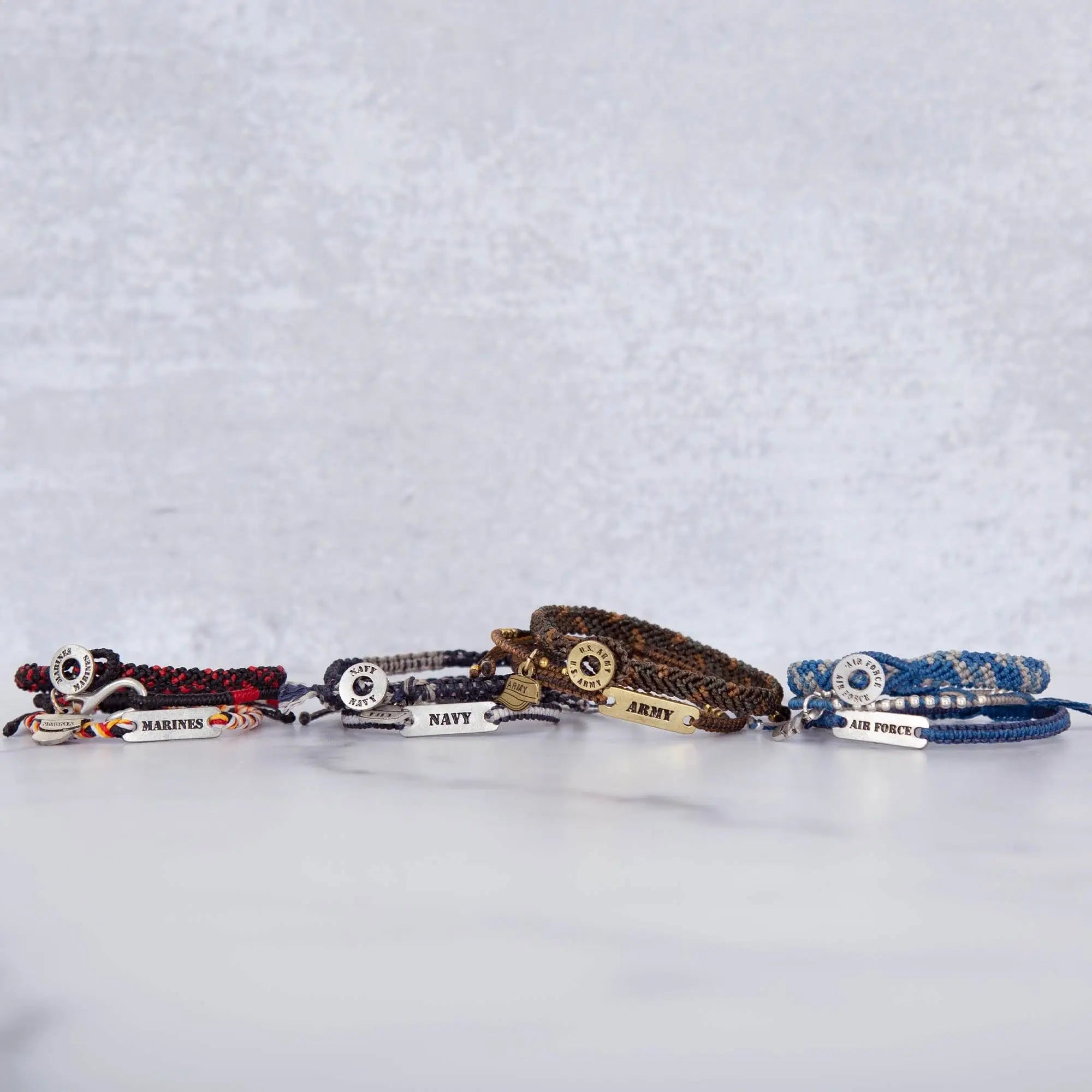 Military hat woven bracelet trio with red navy blue brown and royal blue woven bands and engraved metallic tags