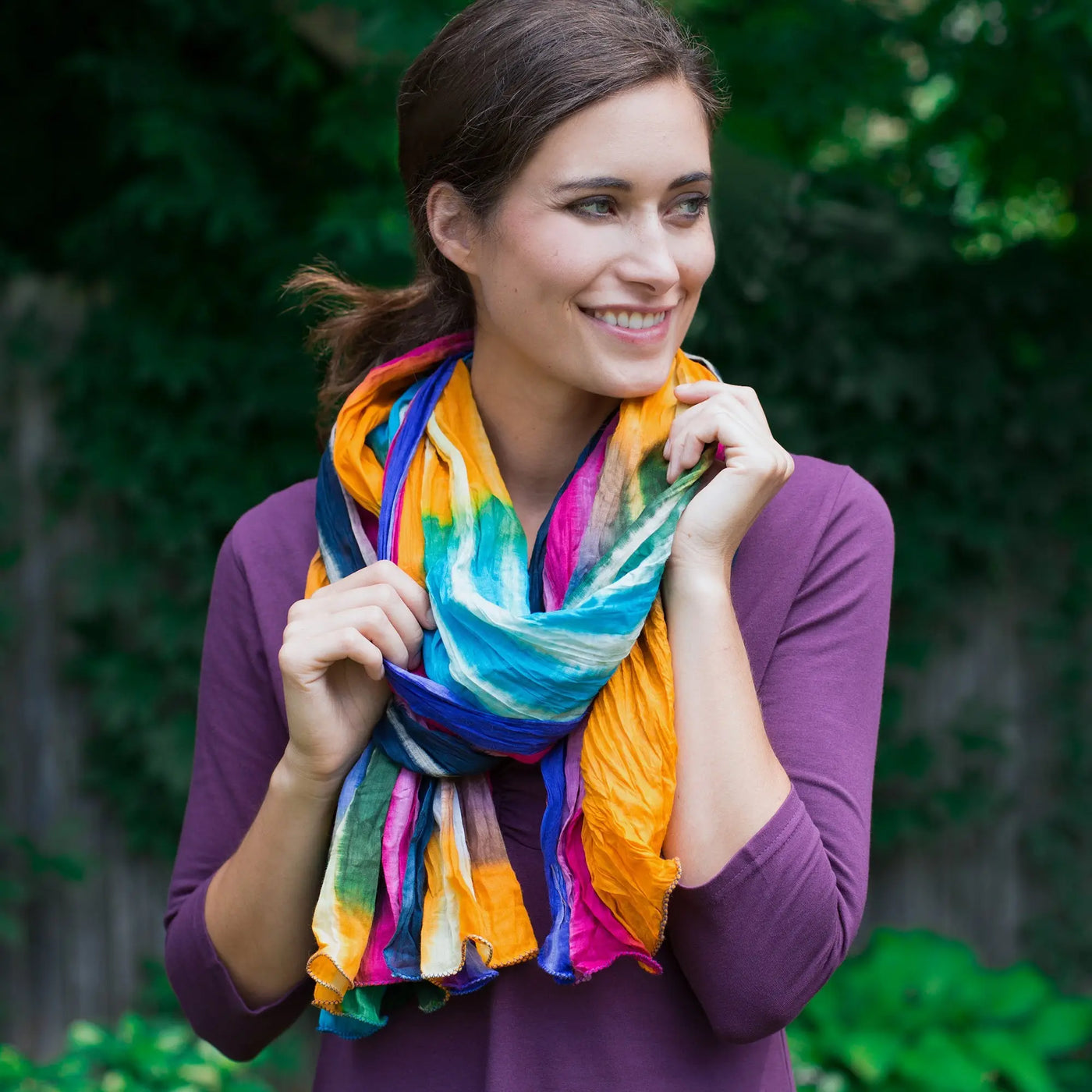 Northern lights cotton scarf with vibrant multicolored tie-dye soft flowing fabric draped around model’s neck fair trade