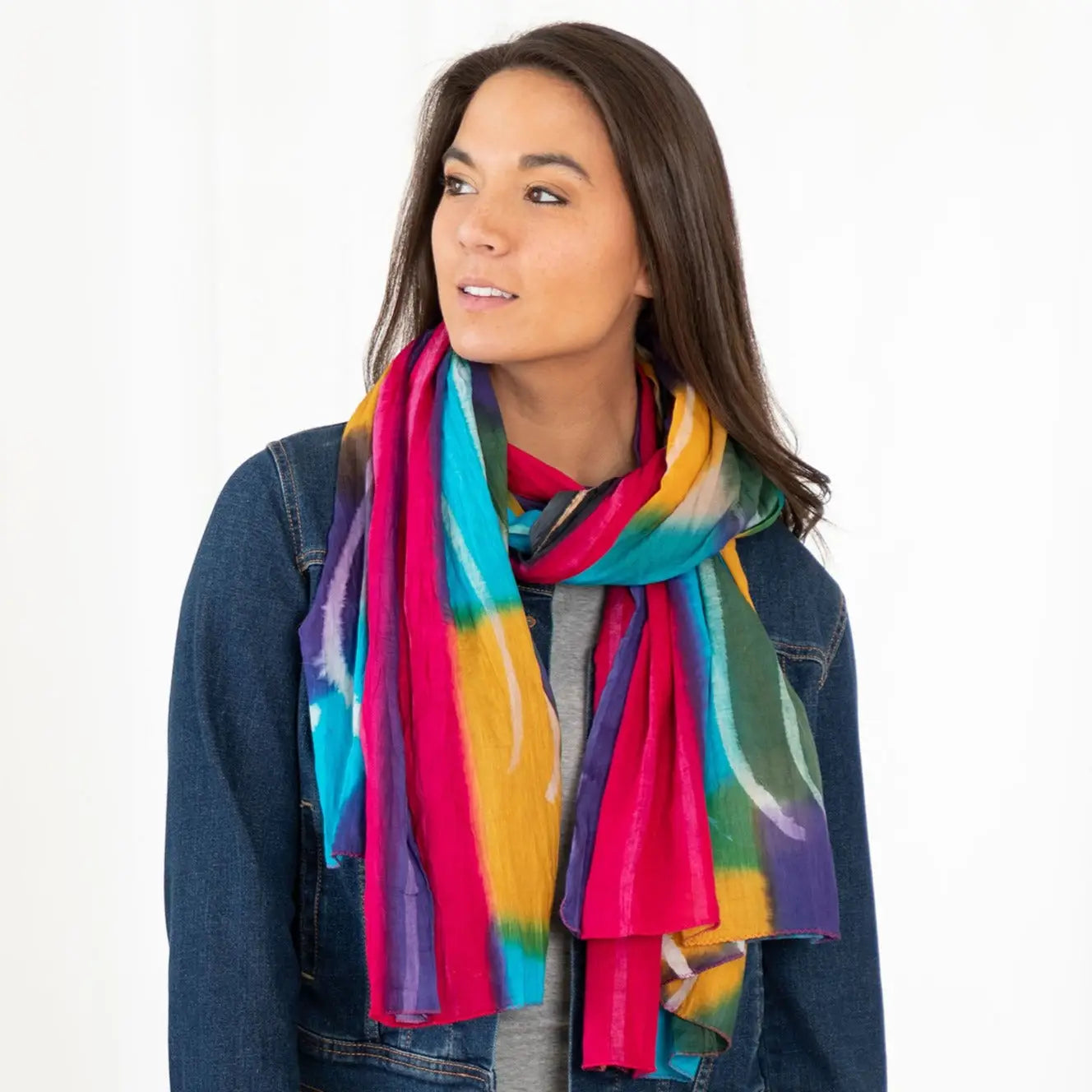 Northern Lights cotton scarf fair trade vibrantly tie-dyed in bold pink teal yellow and purple stripes draped around neck