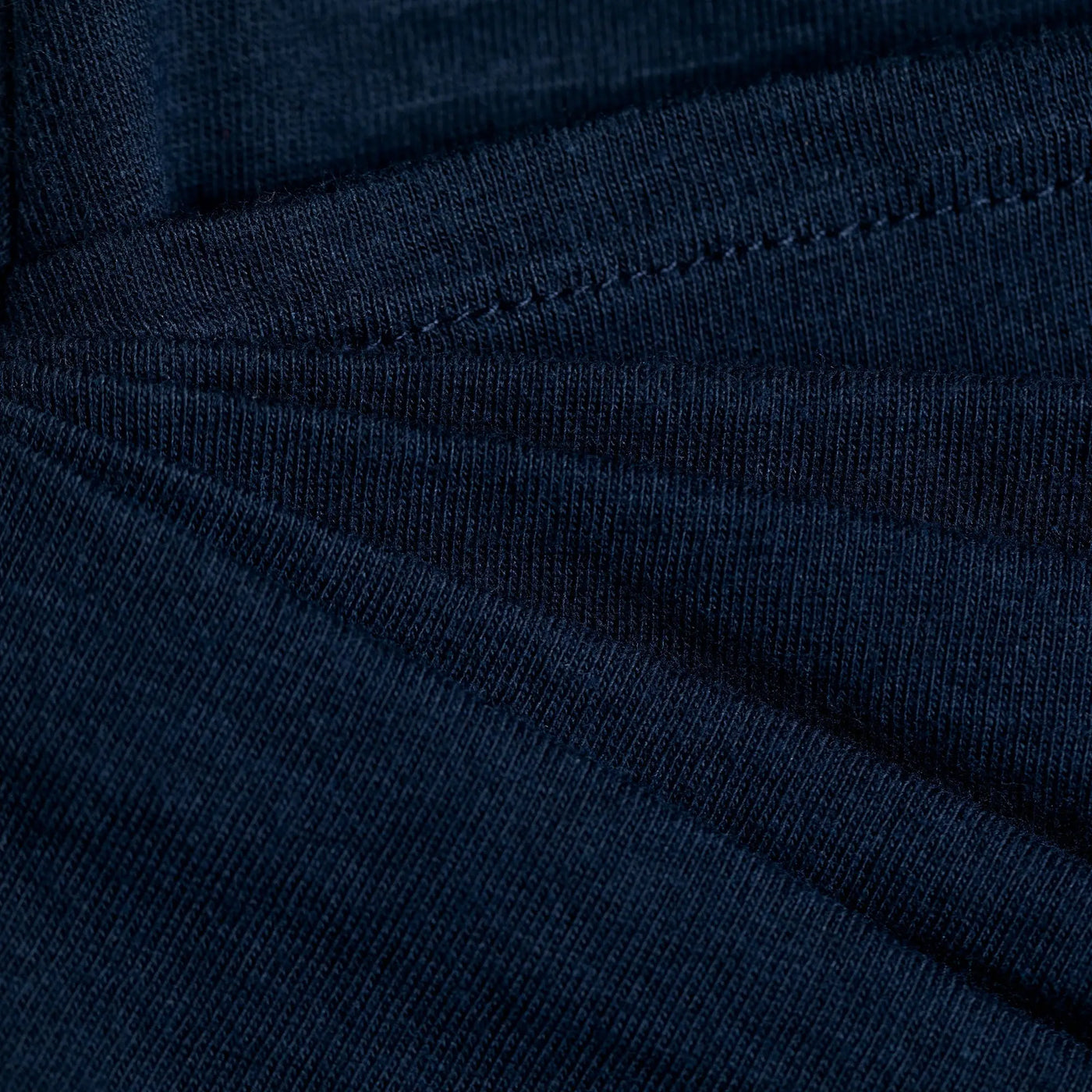 Dark blue ribbed knit organic layered pencil skirt showing visible stitching along the seams