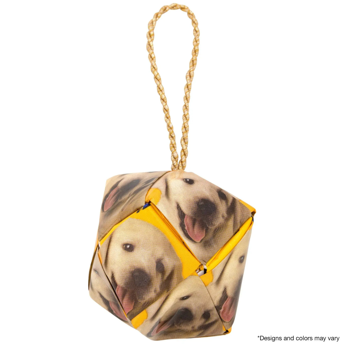 A cube-shaped recycled dog food ornament doorstop with a playful labrador face yellow edges and gold rope handle