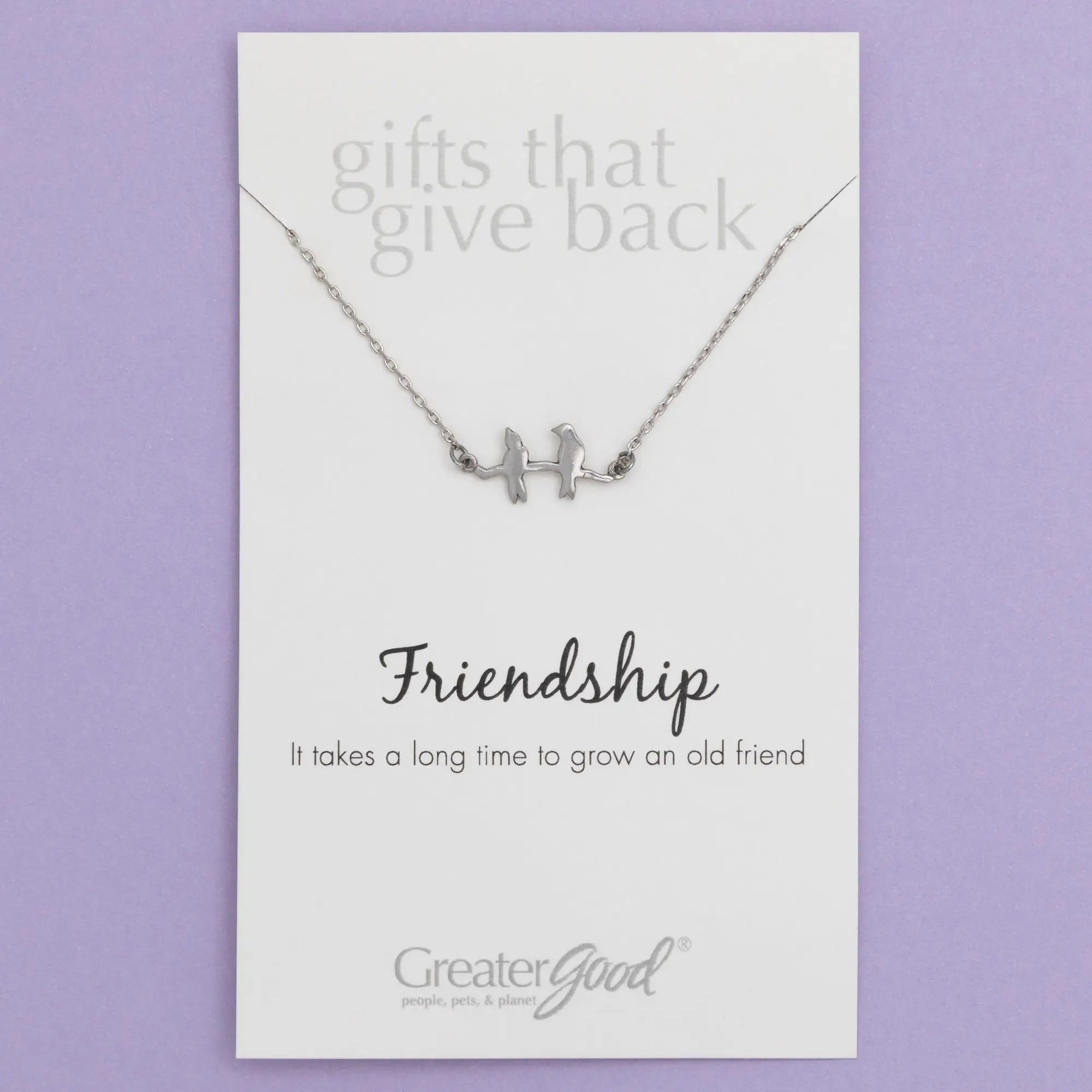 Silver sisterly love necklace with delicate chain and two gemstone adorned stylized bird figures on a branch