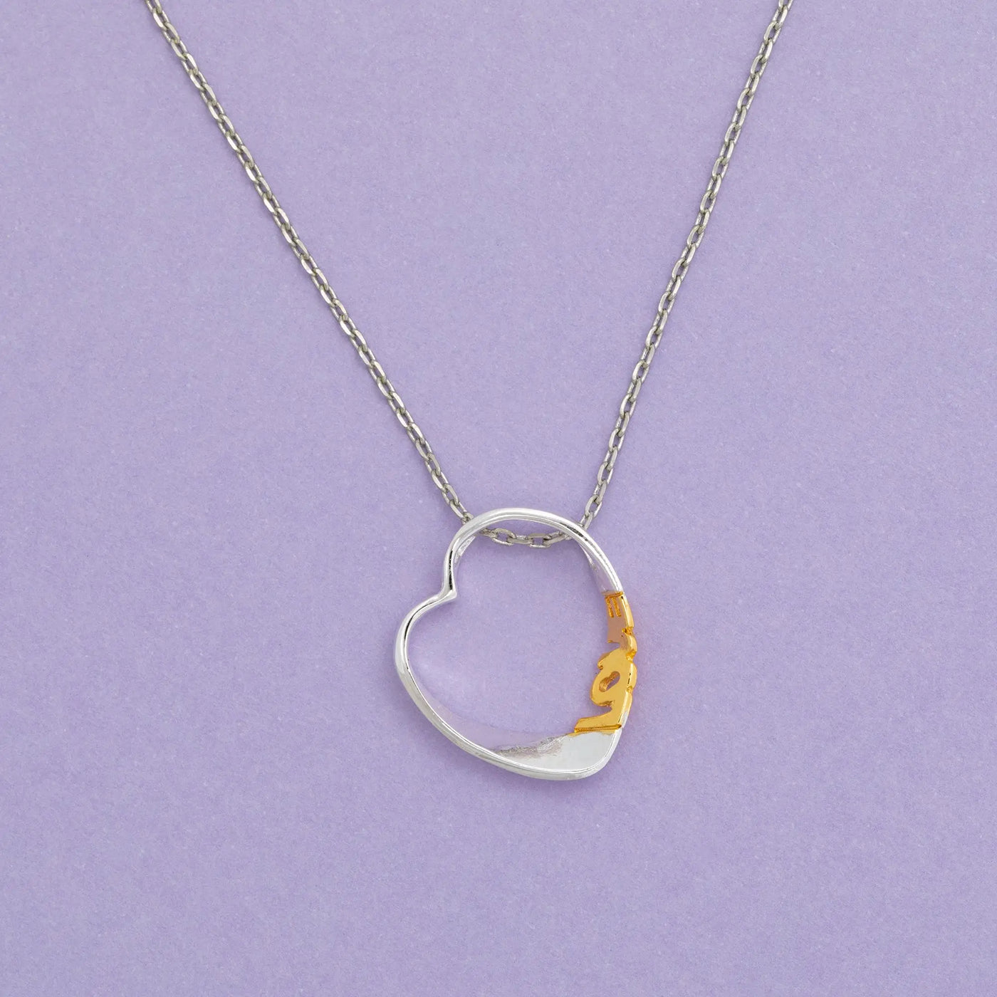 Silver and gold heart shaped pendant necklace with delicate chain from sisterly love necklace collection