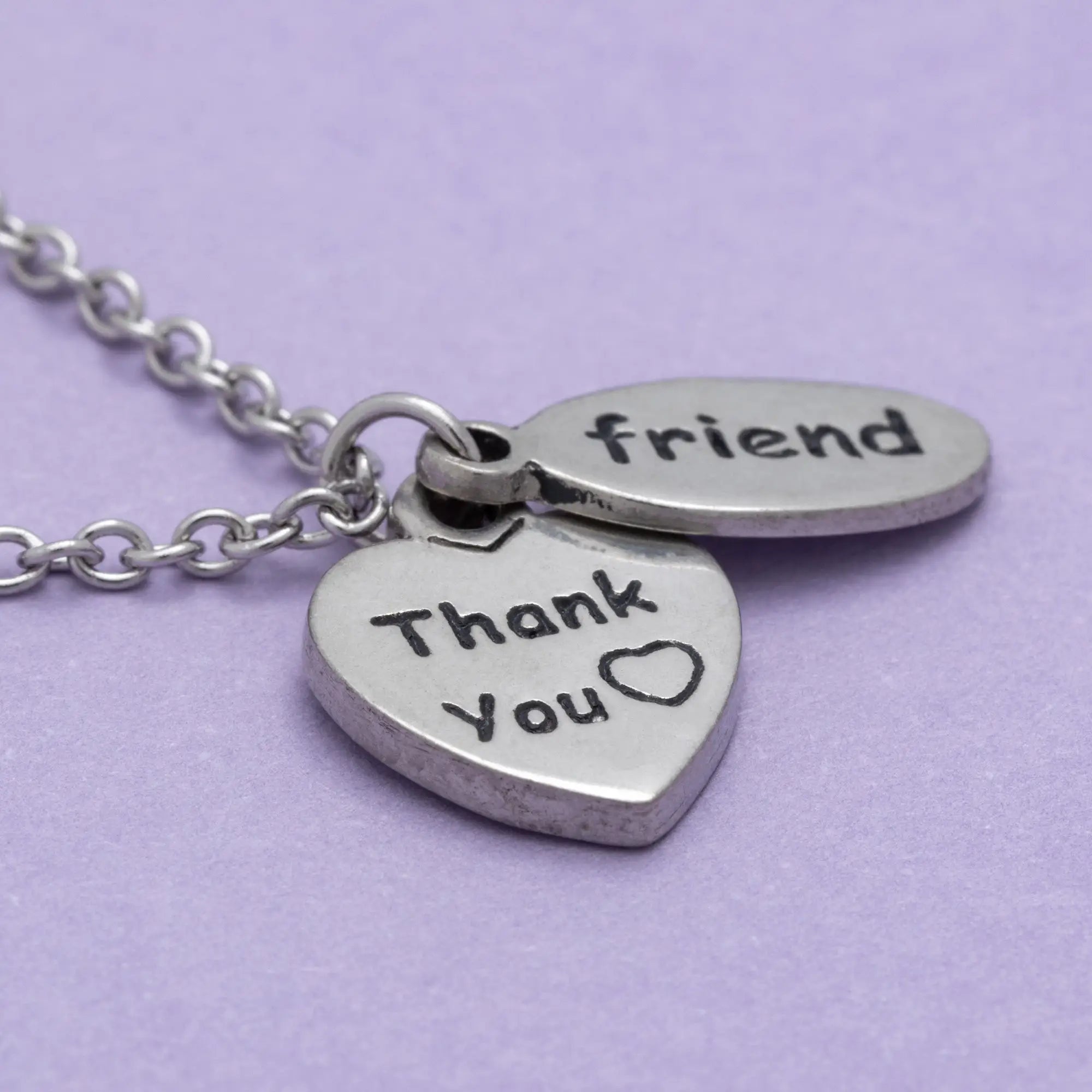 Silver heart and oval pendant necklace engraved with thank you and friend on a delicate chain sisterly love necklace