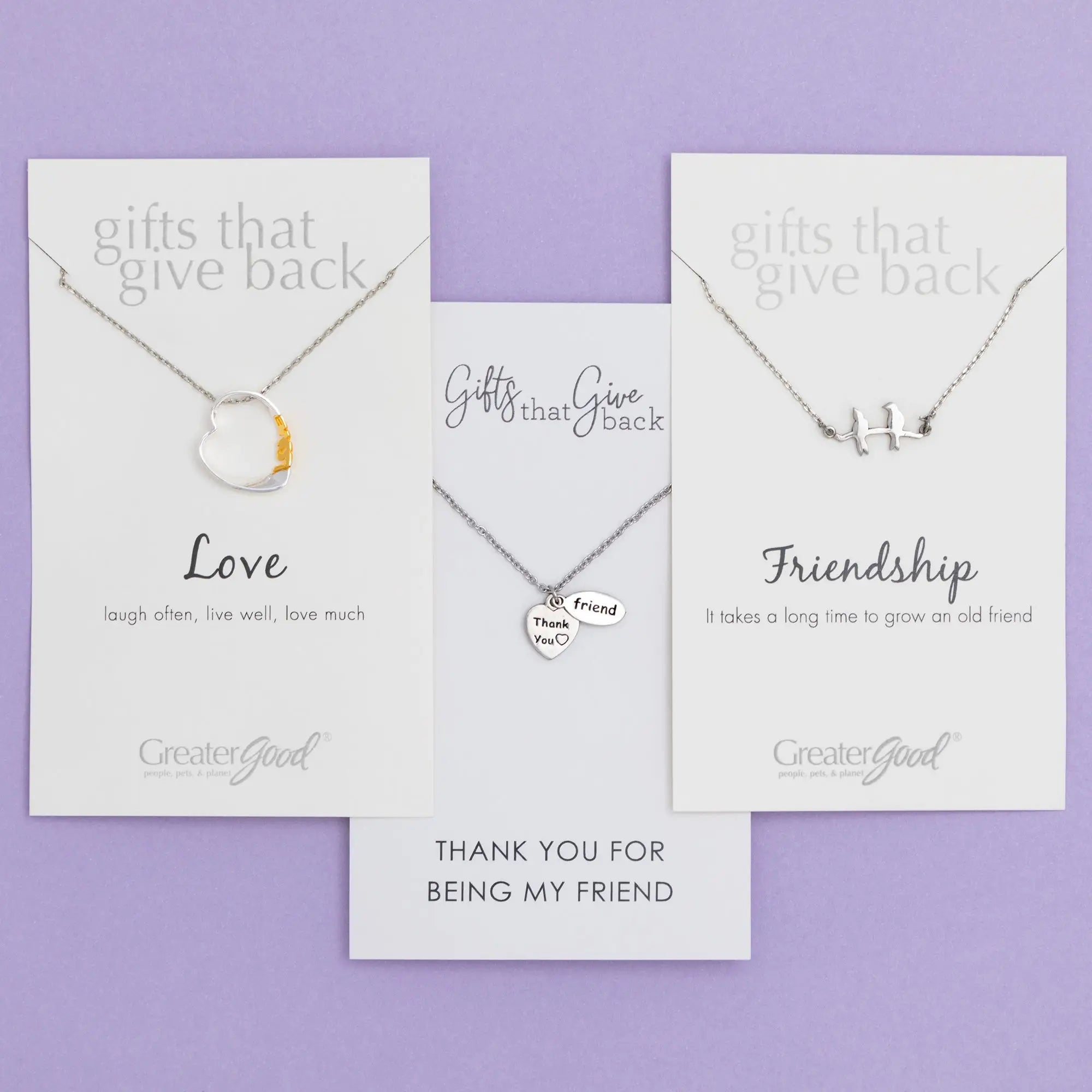 Silver heart-shaped pendant necklace with gold accent featuring love theme on branded card for sisterly love