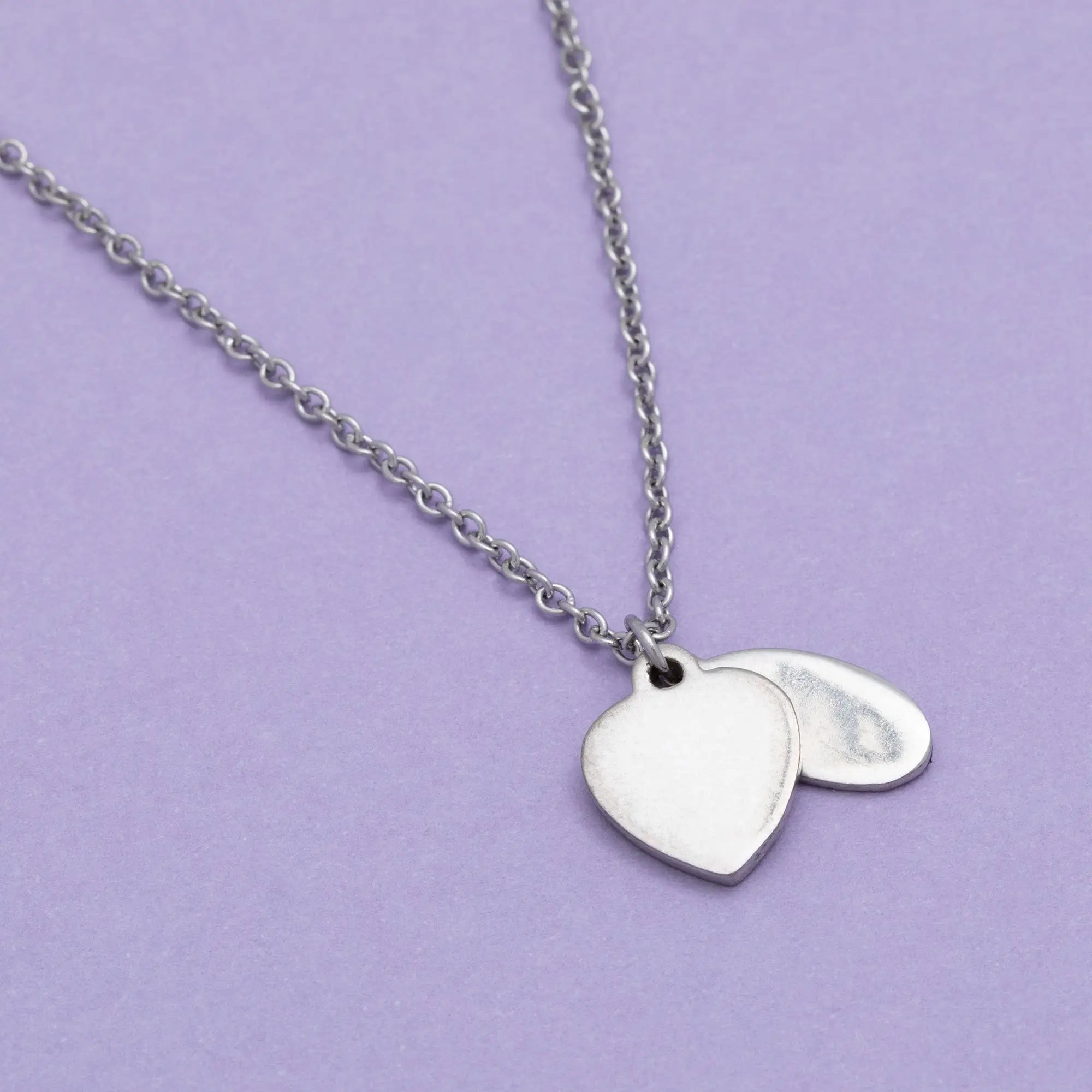 Silver heart-shaped pendant necklace with a delicate chain in the sisterly love collection