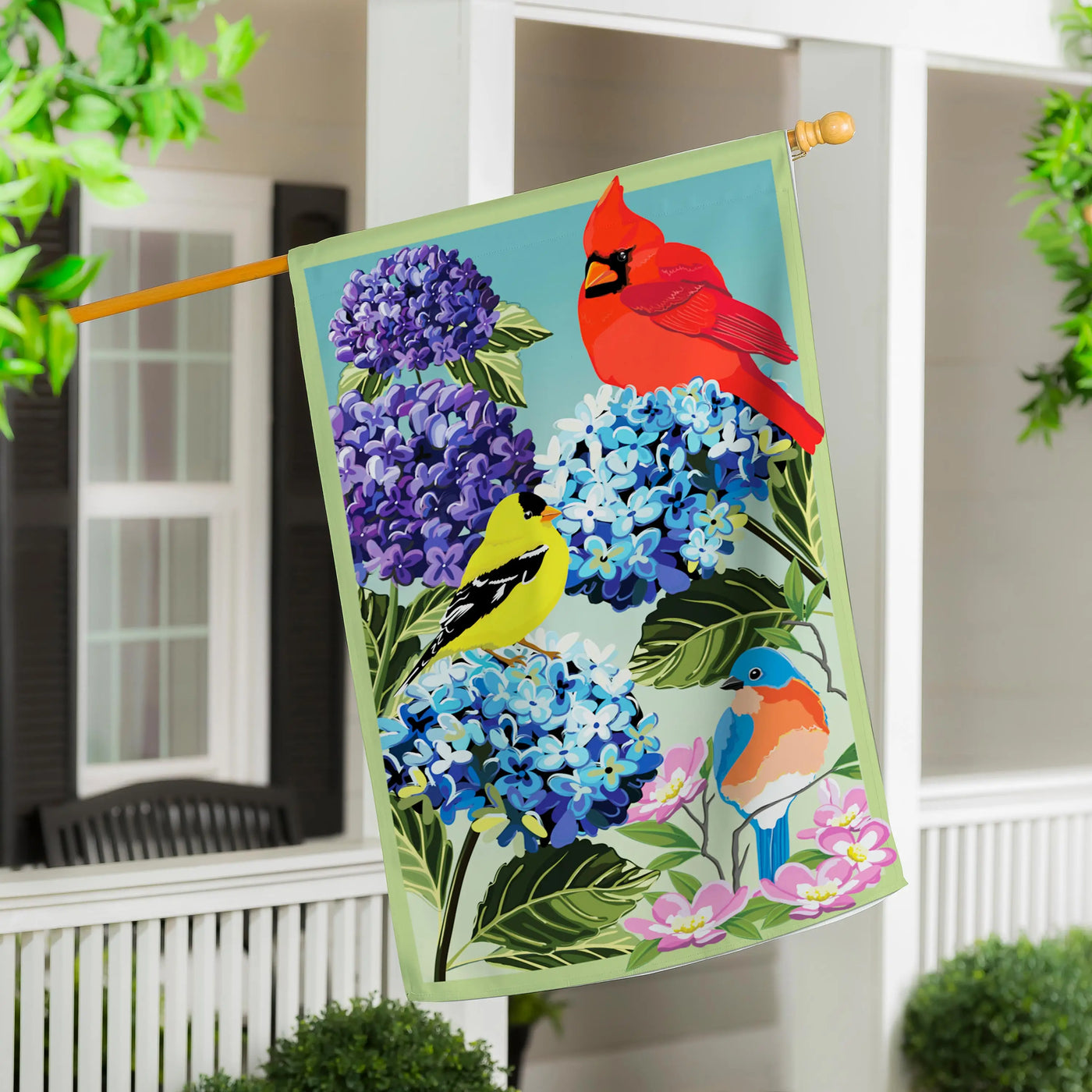 Songbird sonata applique house flag with a red cardinal yellow finch and blue bird among purple blue hydrangeas and pink flowers
