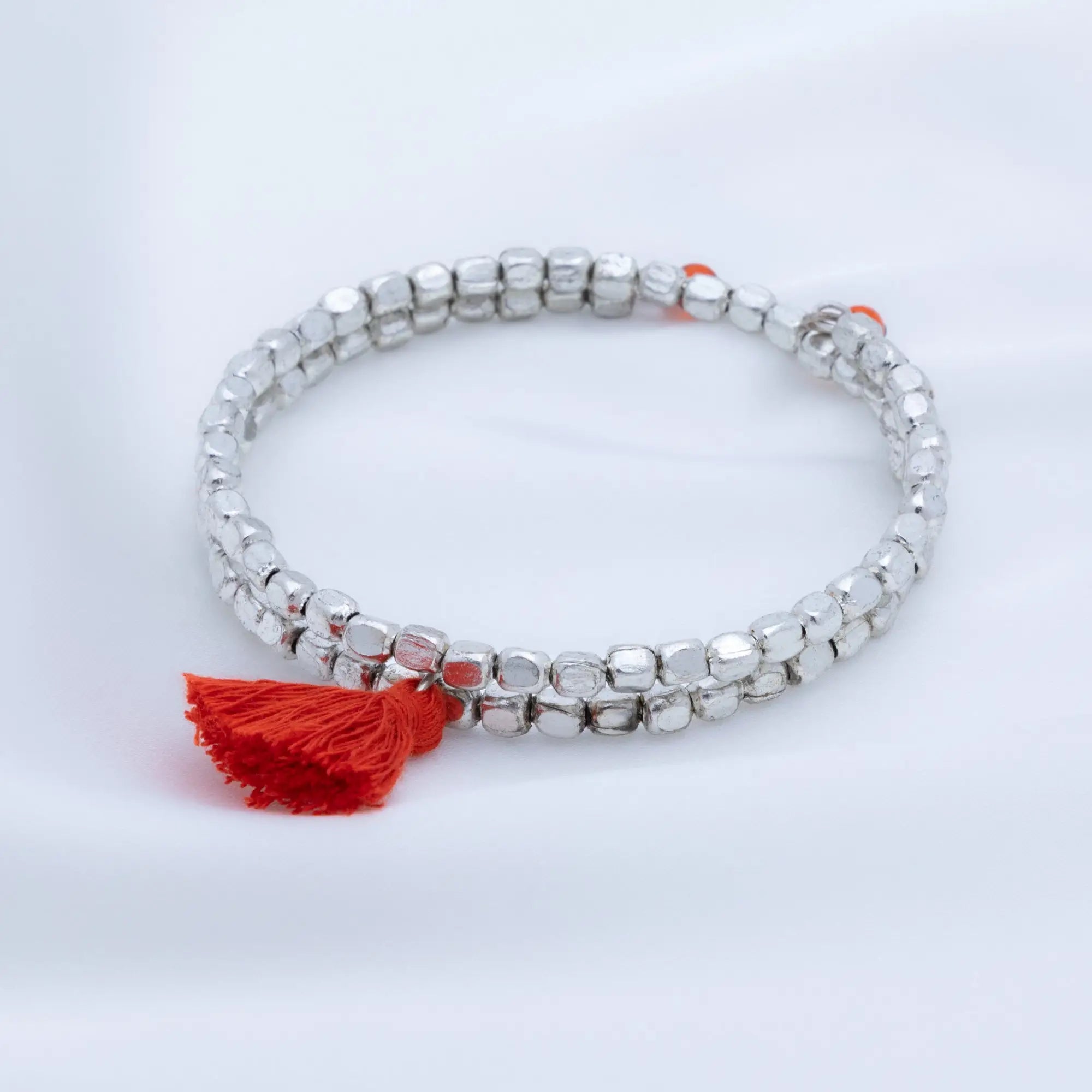 Silver beaded taj tassel metal bead bracelet with a vibrant red tassel accent perfect for stylish wear