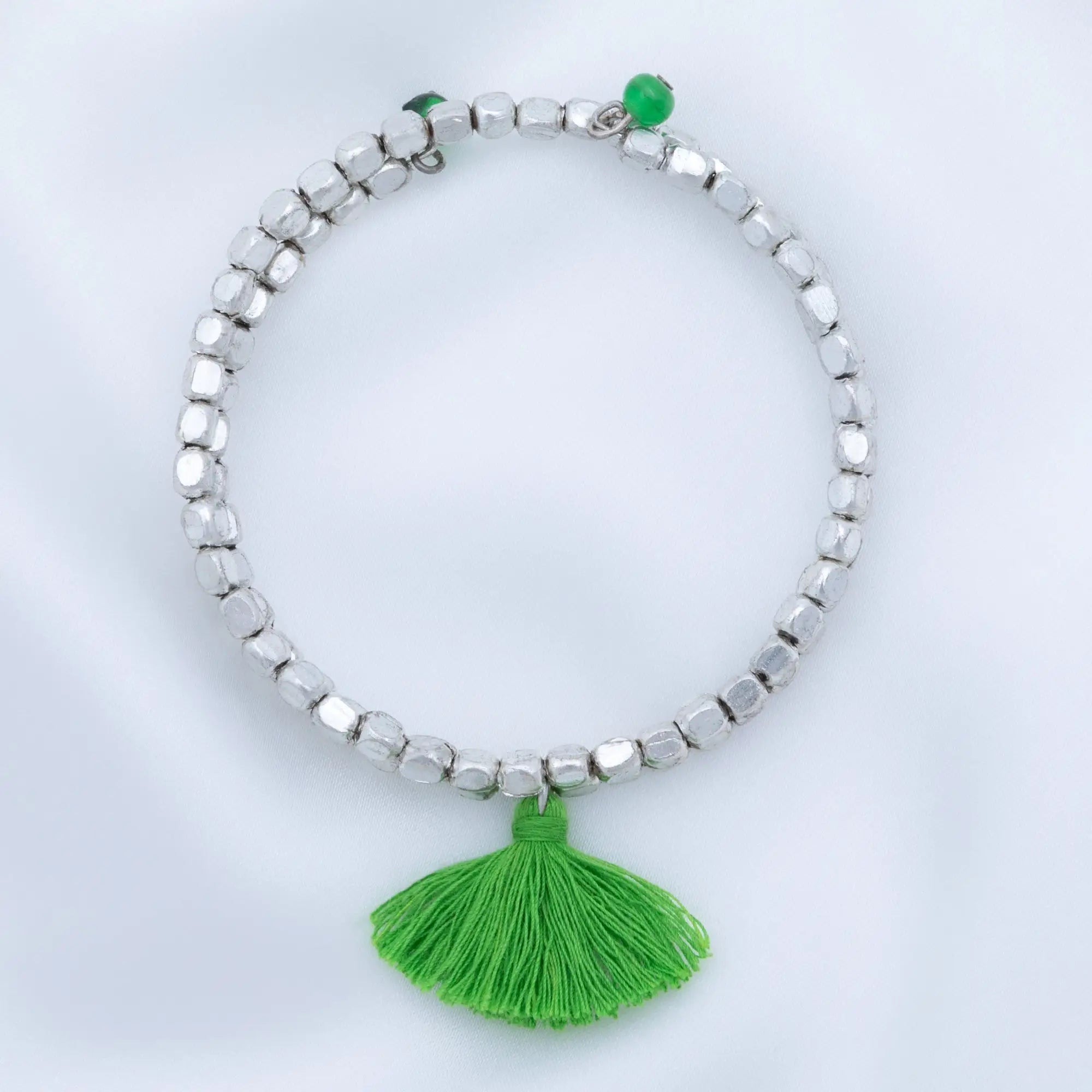 Silver beaded Taj tassel metal bead bracelet with vibrant green tassel and matching green bead accent