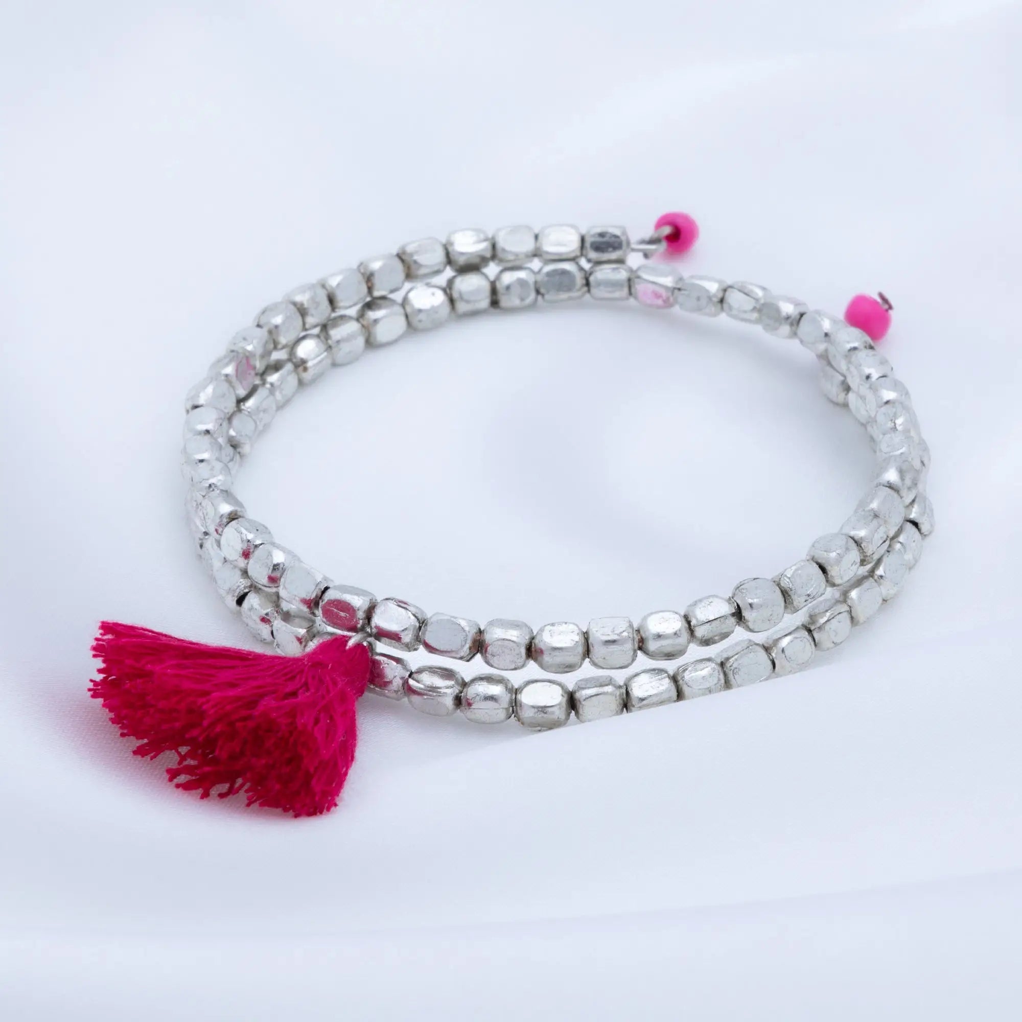 Silver beaded Taj tassel metal bracelet with vibrant pink tassel and matching pink bead accents