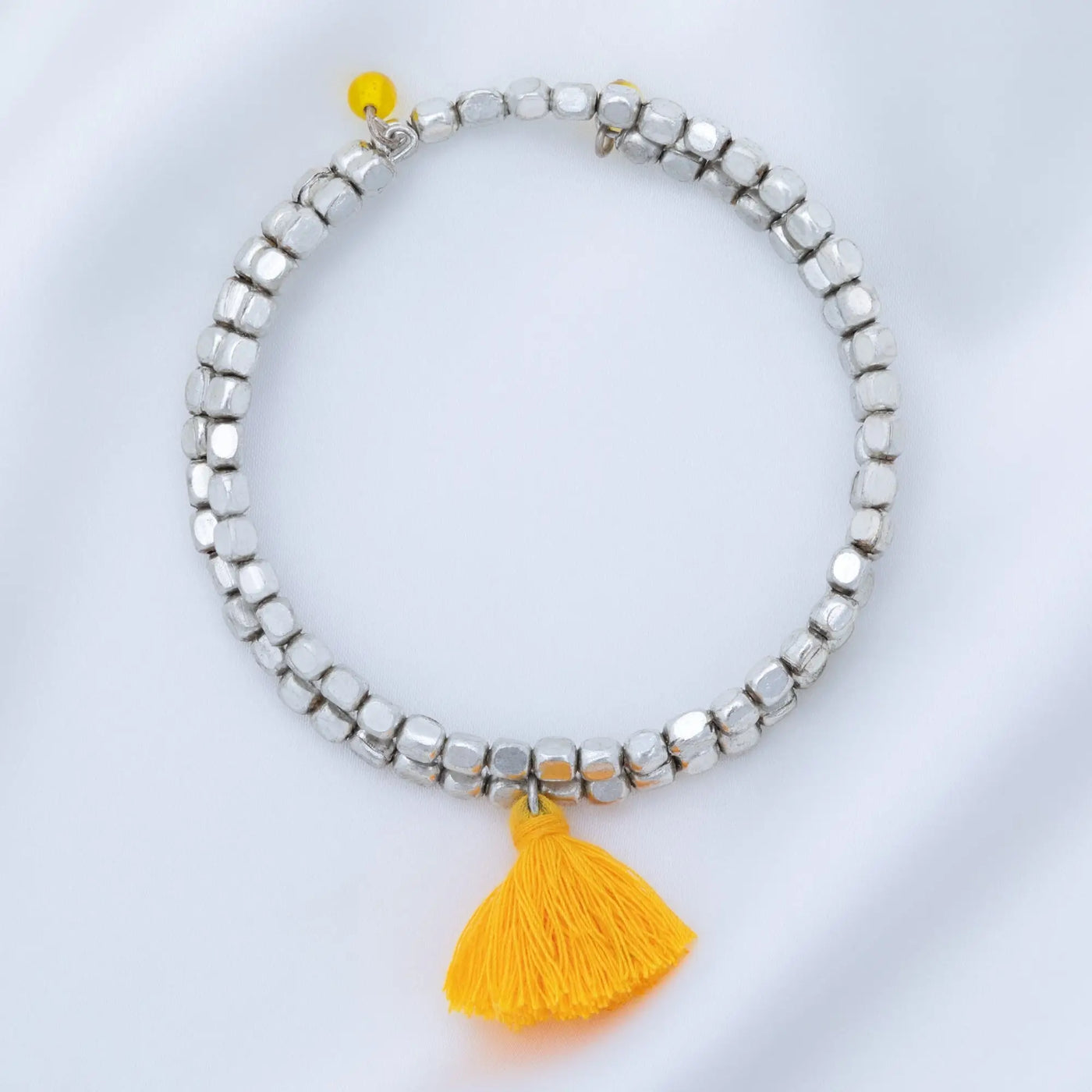 Silver beaded taj tassel metal bead bracelet with a bright yellow tassel charm for stylish everyday wear