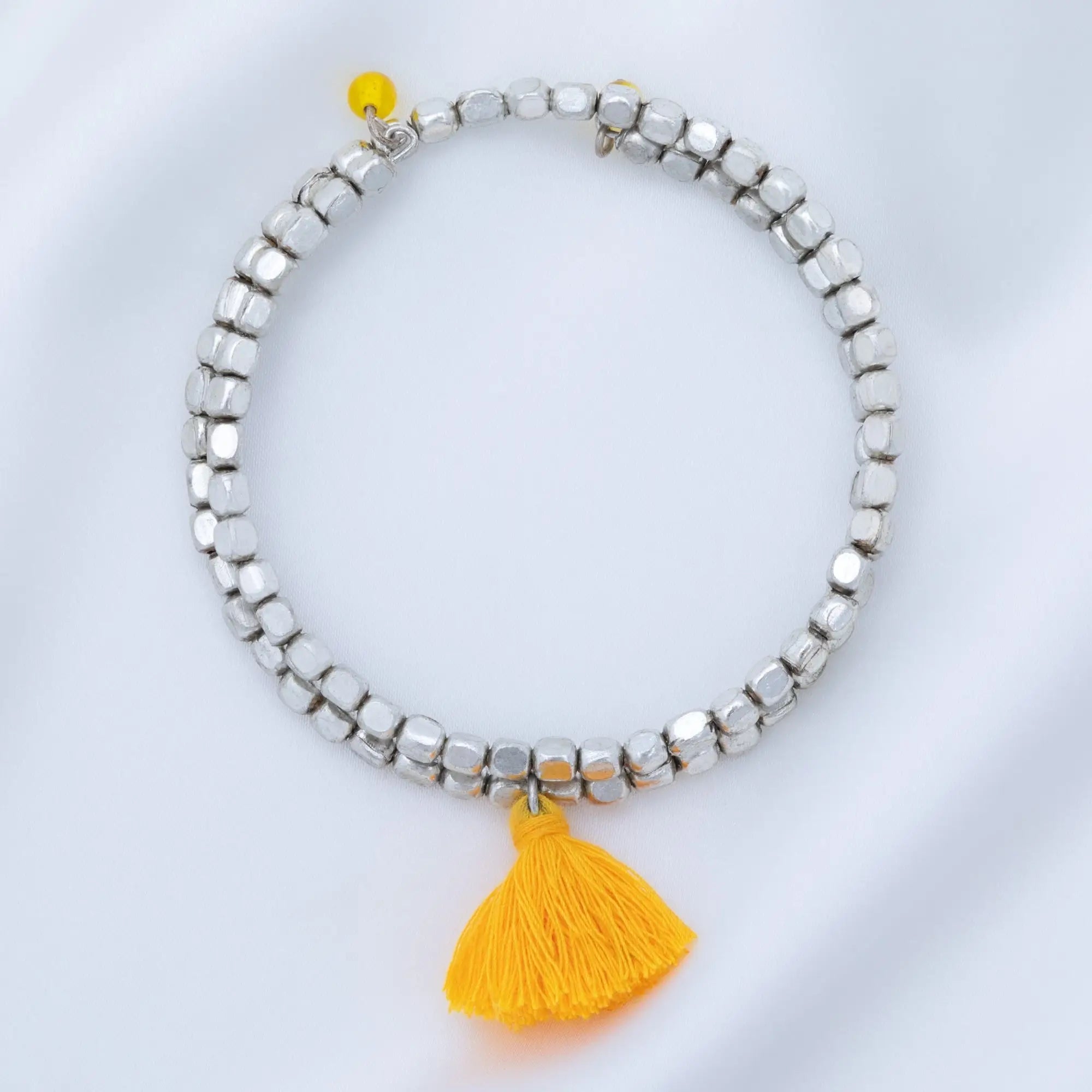 Silver beaded taj tassel metal bead bracelet with a bright yellow tassel charm for stylish everyday wear