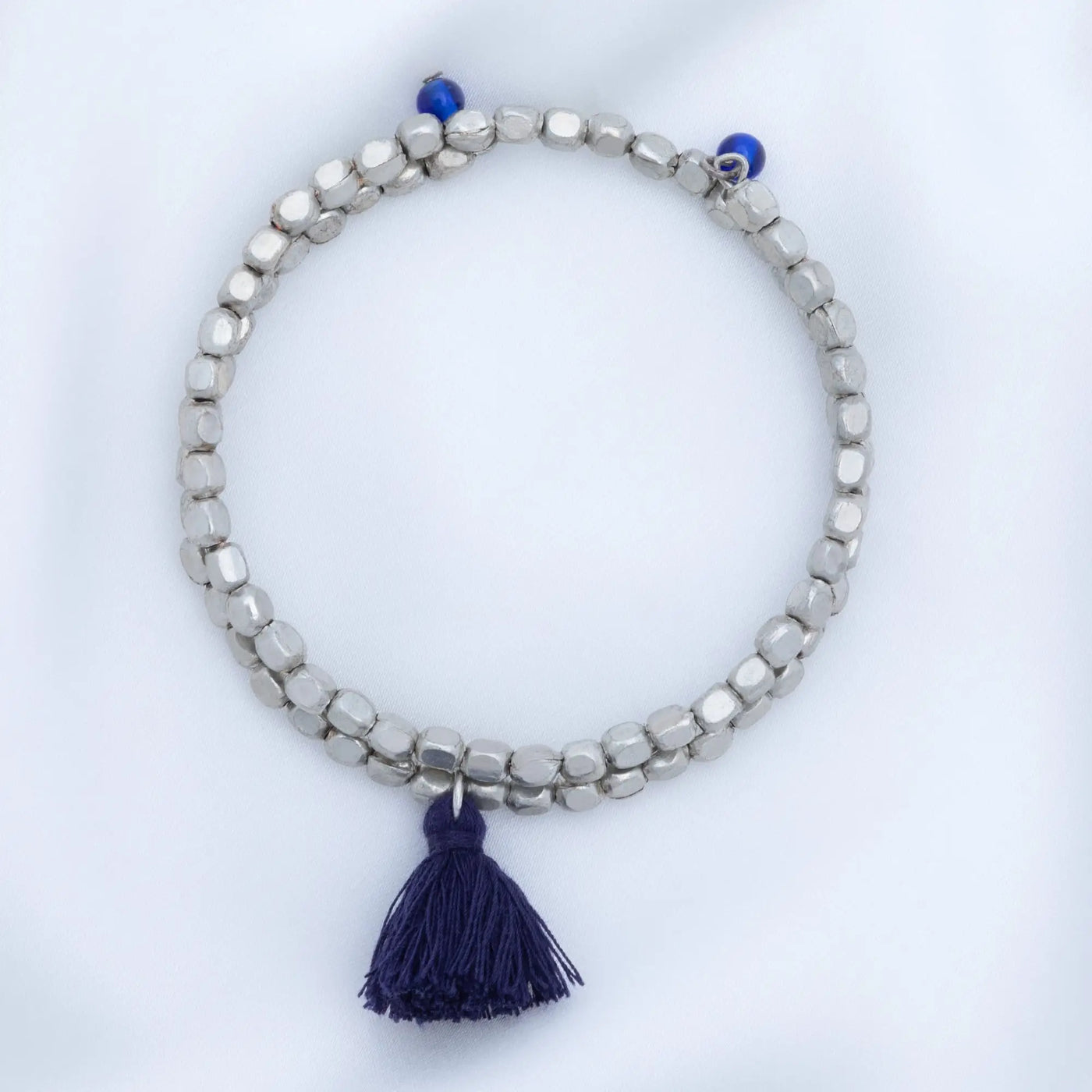 Silver beaded Taj tassel metal bead bracelet with navy blue tassel and accent beads for stylish wear