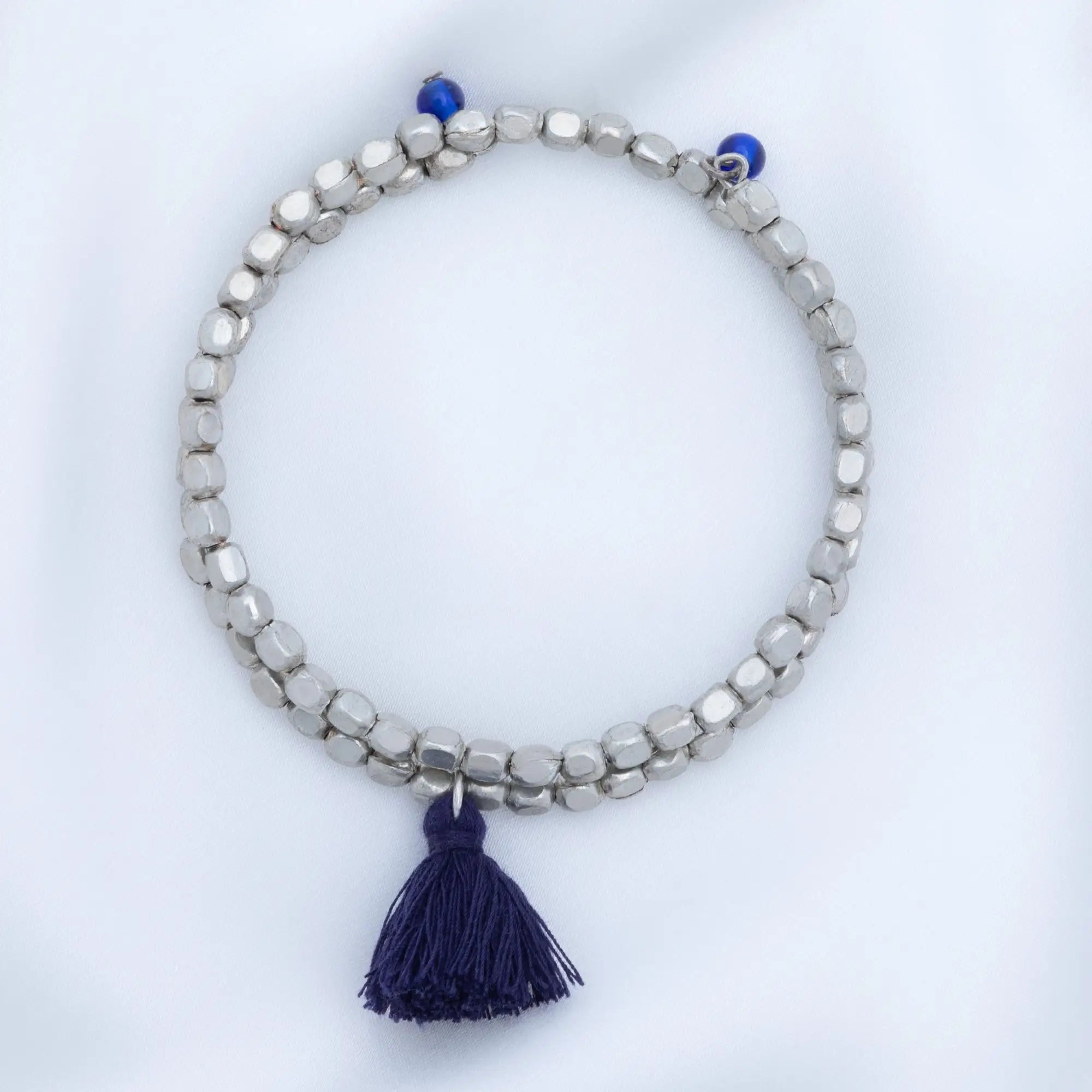 Silver beaded Taj tassel metal bead bracelet with navy blue tassel and accent beads for stylish wear