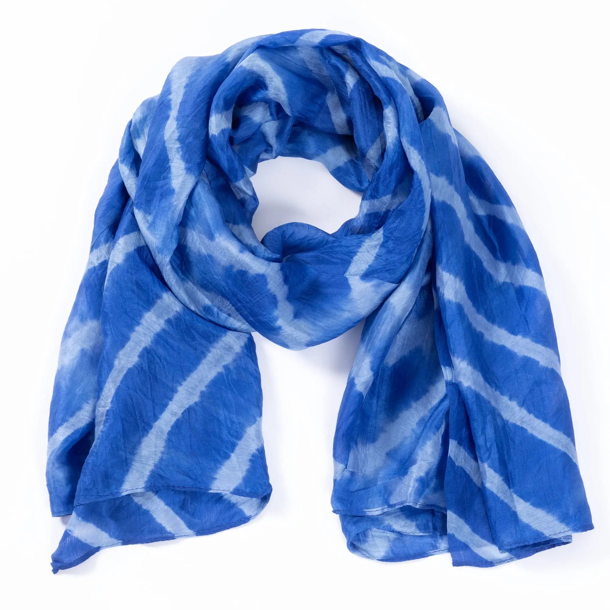 A flowing blue and white tie-dye stripe silk scarf made of soft lightweight fabric for stylish wear