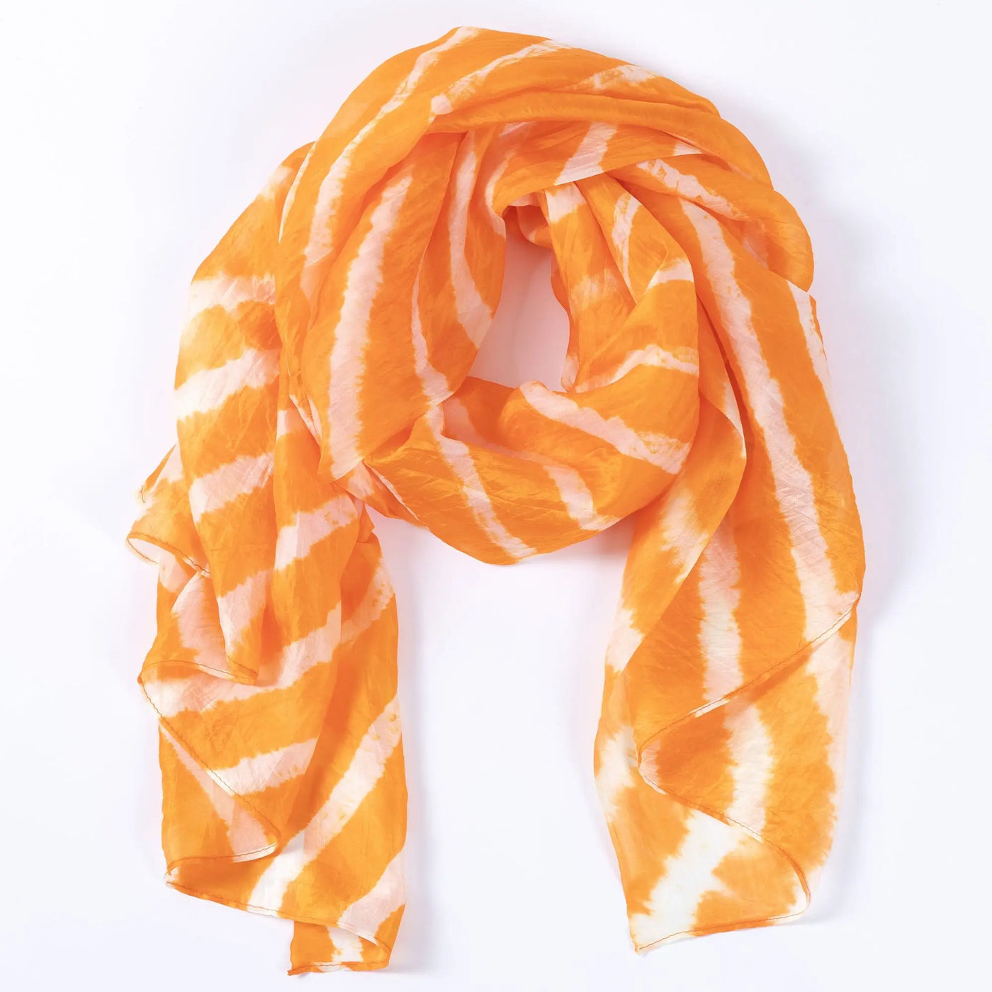 A flowing orange and white tie-dye stripe silk scarf with soft wavy stripes perfect for stylish wear