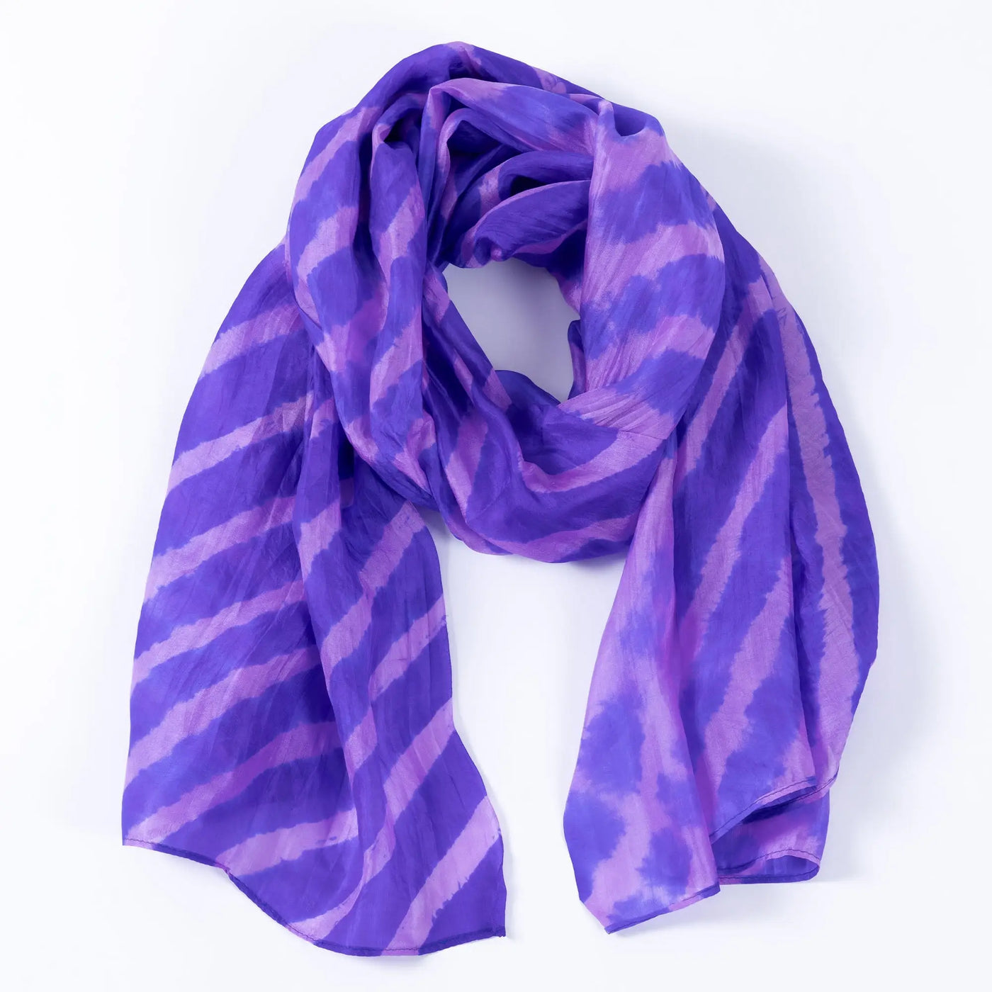 A flowing purple and lavender striped tie-dye silk scarf with a soft lightweight drape
