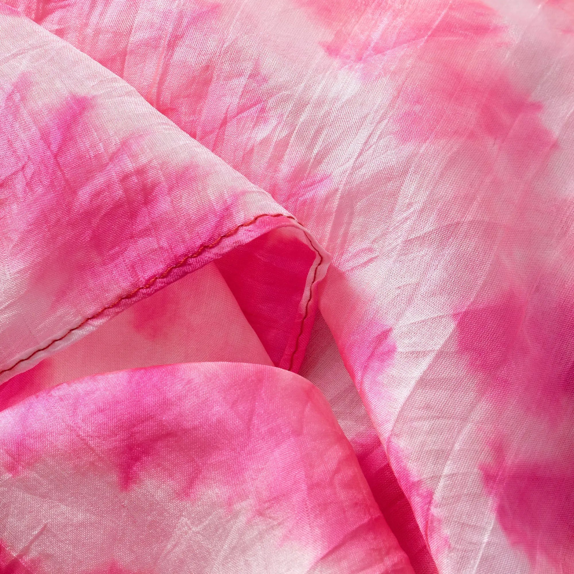 A soft flowing pink tie-dye stripe silk scarf with vibrant fuchsia and pale blush hues