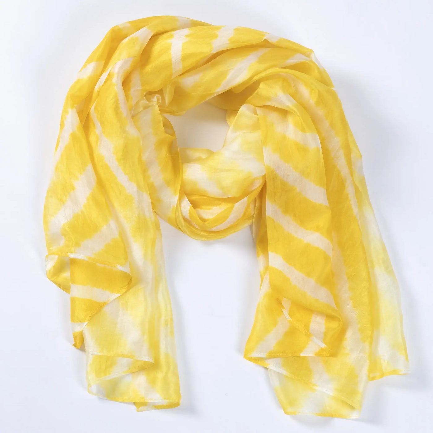 A flowing yellow and white tie-dye stripe silk scarf made of soft, lightweight fabric for stylish wear