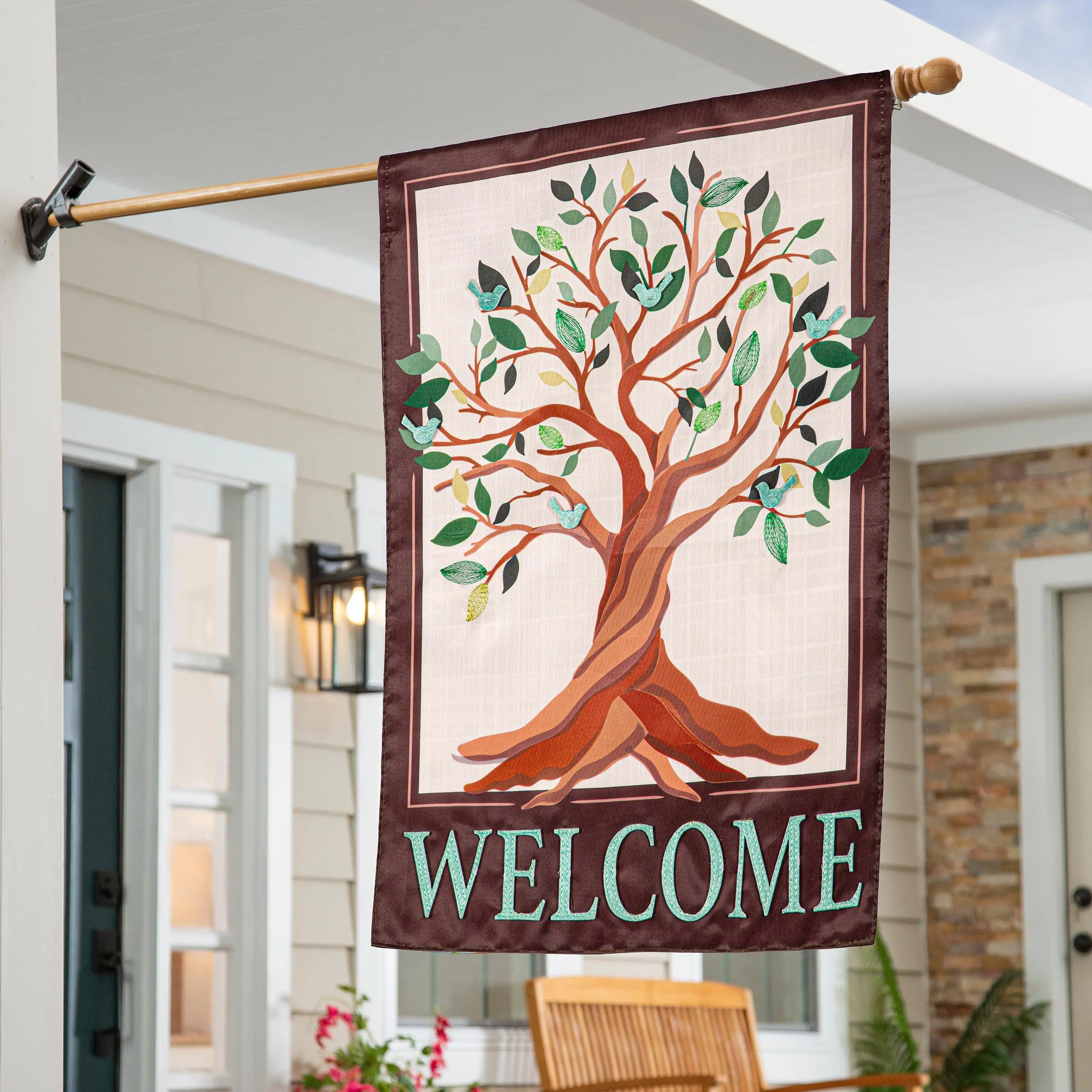 Brown tree of life applique house flag with stylized green tree and blue birds bordered in dark maroon fabric